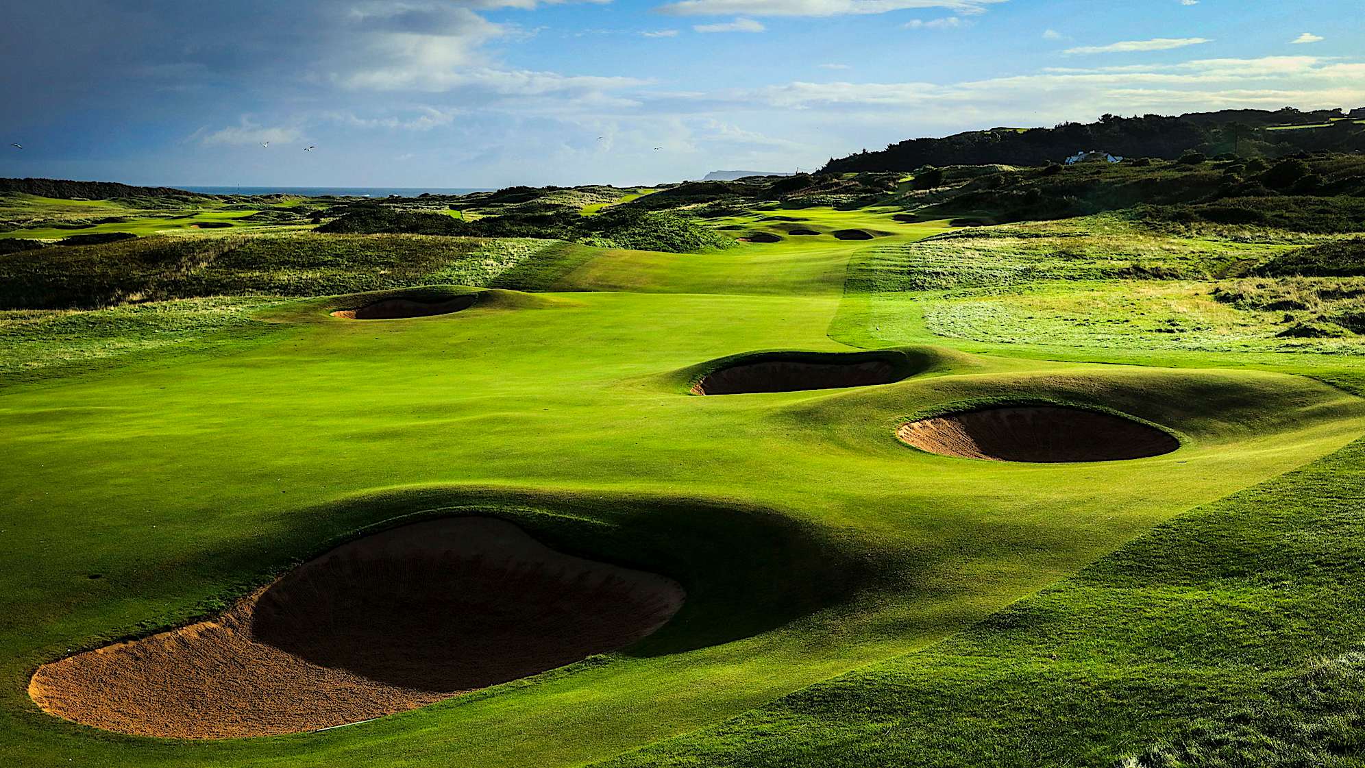 GIANT'S GRAVE: Hole No. 2 has a new tee that's added some steel to the drive of the first par 5 with three bunkers to be avoided up the right. A new bunker on the left side of the fairway will also come into the player’s mind. A good drive is key to making an eagle or birdie as being in the fairway will help the player decide whether to carry or lay up in front of the cross bunkers short of the green. The new green takes the contours of the old green as inspiration and is another great example of Harry Colt’s work. (Descriptions courtesy of the R&A)