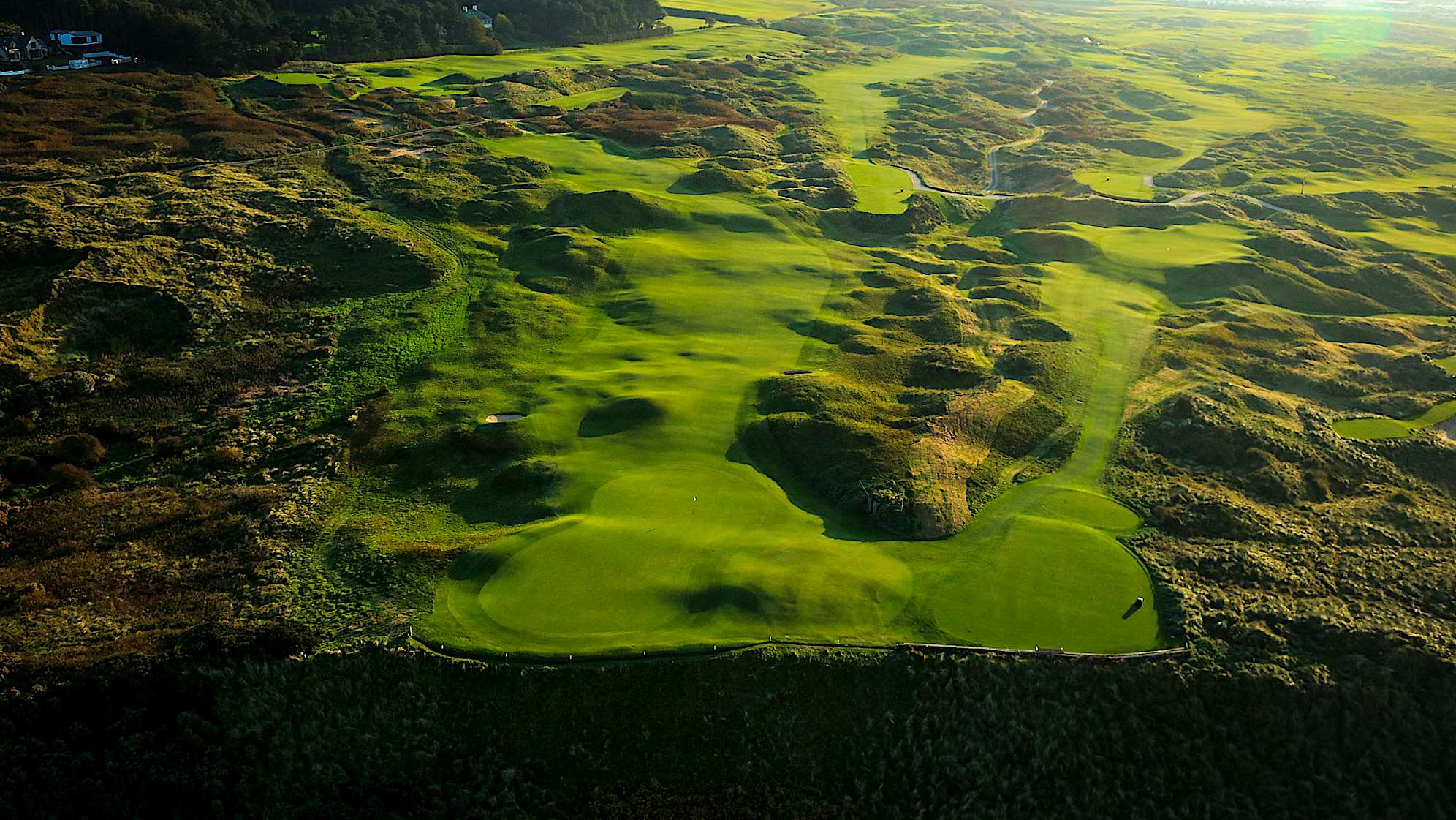 WHITE ROCKS: The fifth hole enjoys a stunning backdrop as its green teeters on the edge of the cliffs. Two new bunkers have added some definition to the tee-shot but expect players to take on the green. It will be a spectacular hole for spectators to watch with the out of bounds just a couple of yards over the back of the green. There is a tier in the green which makes it another challenging one to hit. Players will expect to make a birdie here but also anticipate a variety of scores to be made at this hole. (Descriptions courtesy of the R&A)