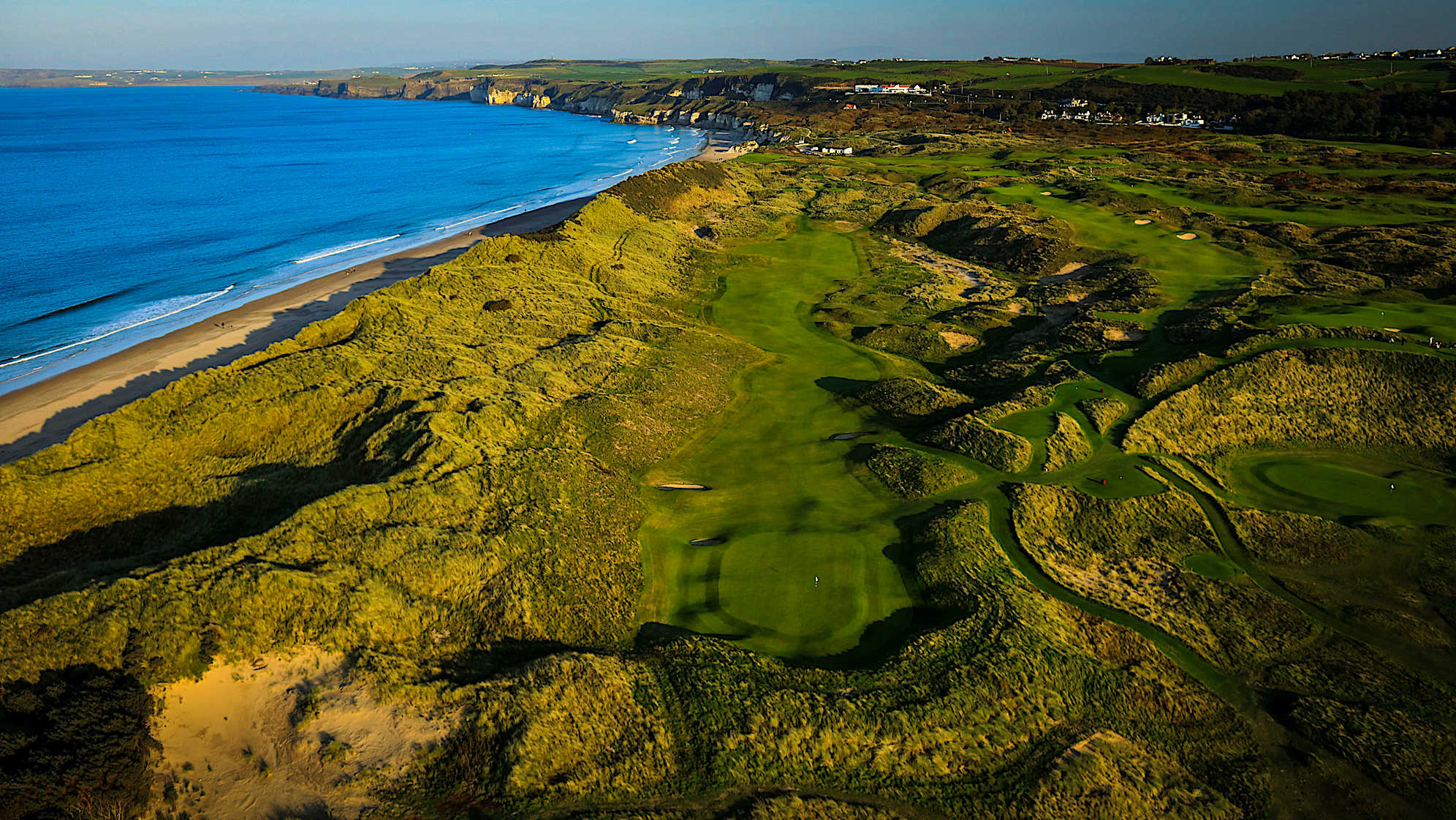 CURRAN POINT: Hole No. 7 is the first of the new holes and a wonderful par 5 cut through the dunes. A downhill tee-shot from an elevated tee greets the players. A replica of the ‘Big Nellie’ bunker on the right-hand side is a spectacular sight but it’s the bunker on the left that will be in play for the professionals. The second shot presents an uphill challenge through a very narrow approach to a well-contoured green. The wind conditions will determine whether players can take on the green in two shots. (Descriptions courtesy of the R&A)