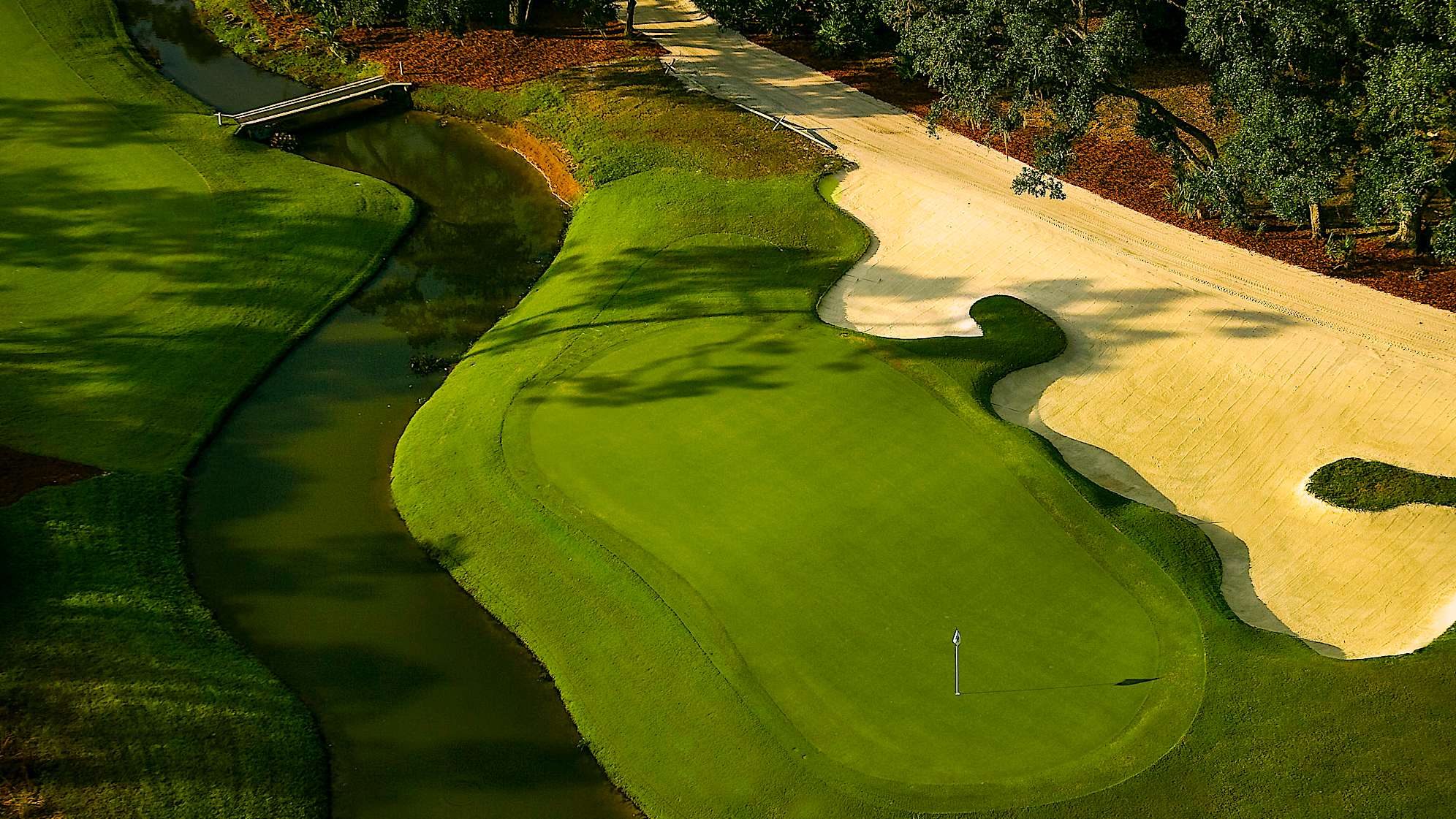 This short par 4 requires a precise driver or fairway metal tee shot to the left center of the fairway. The small green is fronted by Tortoise Creek and guarded by a large bunker on the left.