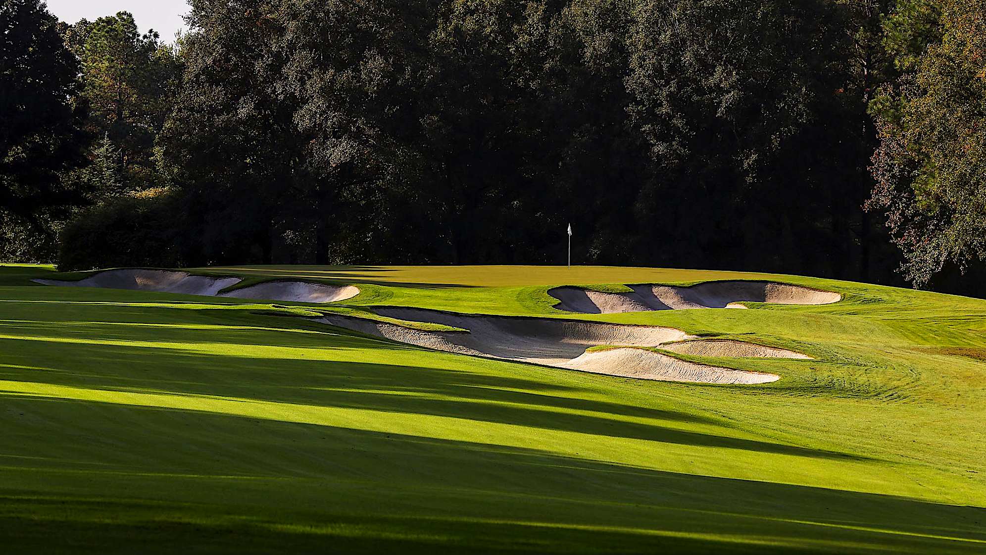 A slight-dogleg right first hole with a narrow landing area creates the need for accuracy. A 3-wood tee shot works best to navigate around a bunker on the right side of the landing area. Players must also be precise on their approach shot, because the green is where this hole gets tricky. Since it is crowned and slopes severely from back to front, correct location on the putting surface is paramount to starting the front nine on a positive note.The green on Quail Hollow's signature 17th hole is nearly an island, forcing a 200-yard carry to clear the water. A fade is also required to settle the ball on a precariously perched, back-to-front and right-to-left sloping green. Enjoy the birdie-or-blunder potential this hole presents, as well as the view of the lake stretched out behind the green. (PGA TOUR)