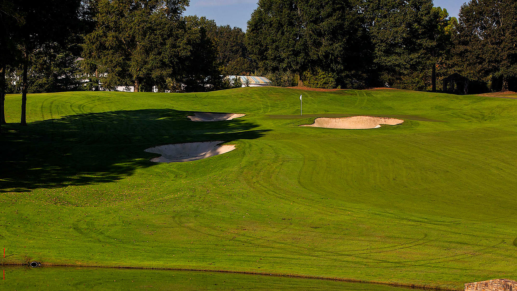 The last of the par 5s, the 15th hole, plays uphill after the tee shot. The water on the left and right of the fairway may appear dangerous. However, it will probably have little effect on the professionals. A ridge running down the middle of the green requires perhaps more caution and an accurate approach.The green on Quail Hollow's signature 17th hole is nearly an island, forcing a 200-yard carry to clear the water. A fade is also required to settle the ball on a precariously perched, back-to-front and right-to-left sloping green. Enjoy the birdie-or-blunder potential this hole presents, as well as the view of the lake stretched out behind the green. (PGA TOUR)