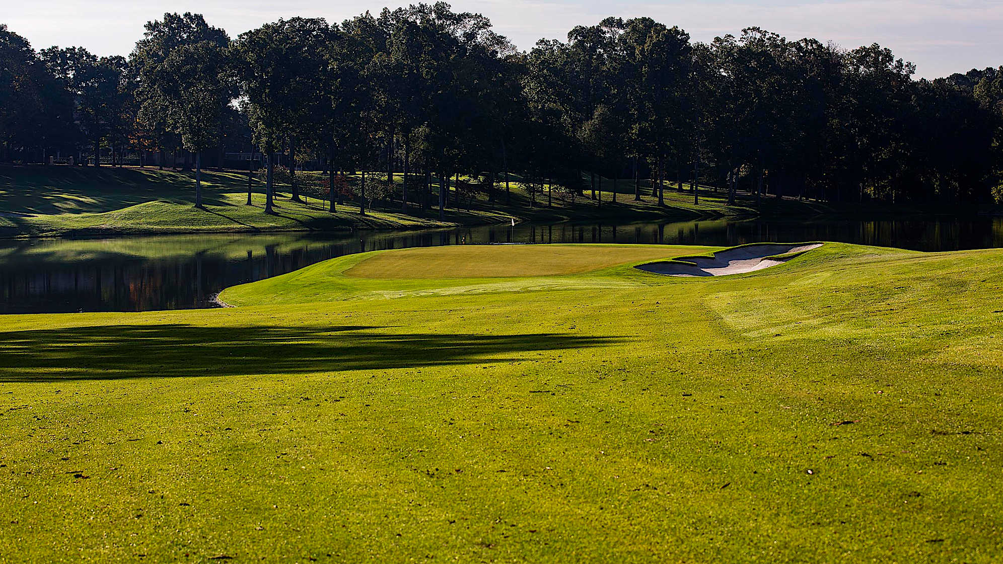 The 16th hole represents the beginning of what has consistently been the toughest final three hole stretch on TOUR. Avoiding the fairway bunker on the right with the tee shot and setting up a mid-iron to the green is advantageous, since this is the most arduous putting surface on the course.The green on Quail Hollow's signature 17th hole is nearly an island, forcing a 200-yard carry to clear the water. A fade is also required to settle the ball on a precariously perched, back-to-front and right-to-left sloping green. Enjoy the birdie-or-blunder potential this hole presents, as well as the view of the lake stretched out behind the green. (PGA TOUR)