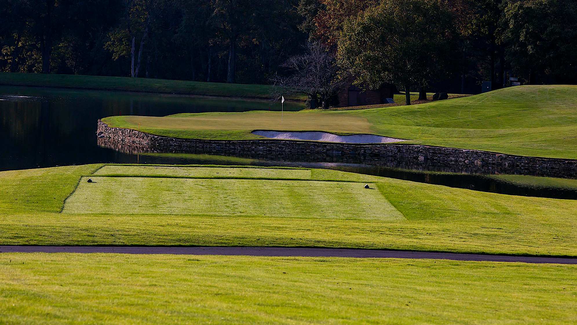 The green on Quail Hollow's signature 17th hole is nearly an island, forcing a 200-yard carry to clear the water. A fade is also required to settle the ball on a precariously perched, back-to-front and right-to-left sloping green. Enjoy the birdie-or-blunder potential this hole presents, as well as the view of the lake stretched out behind the green. (PGA TOUR)