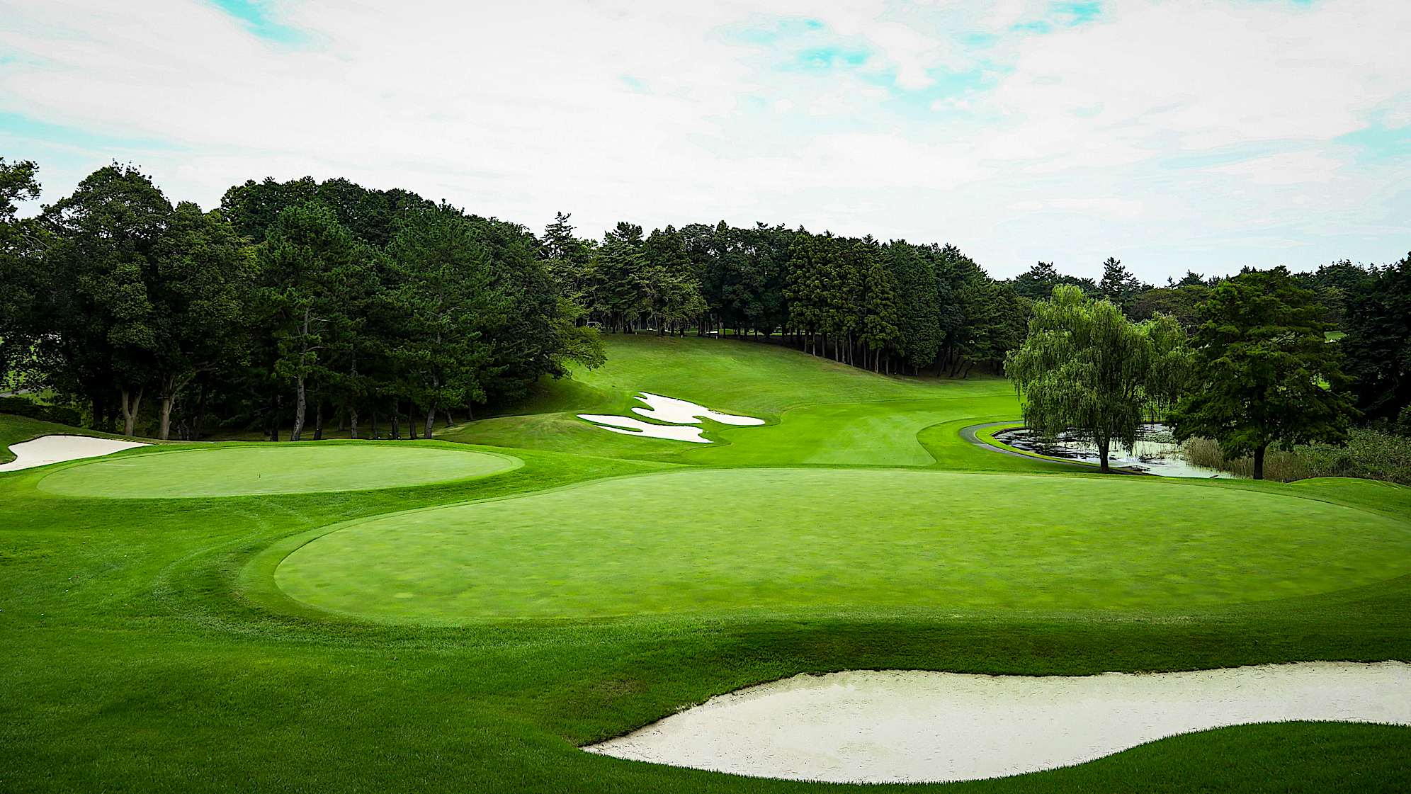 Challenging par 4 with a water hazard running the length of the hole on the left. The second shot is to a steeply elevated green with bunkers on the front and back.