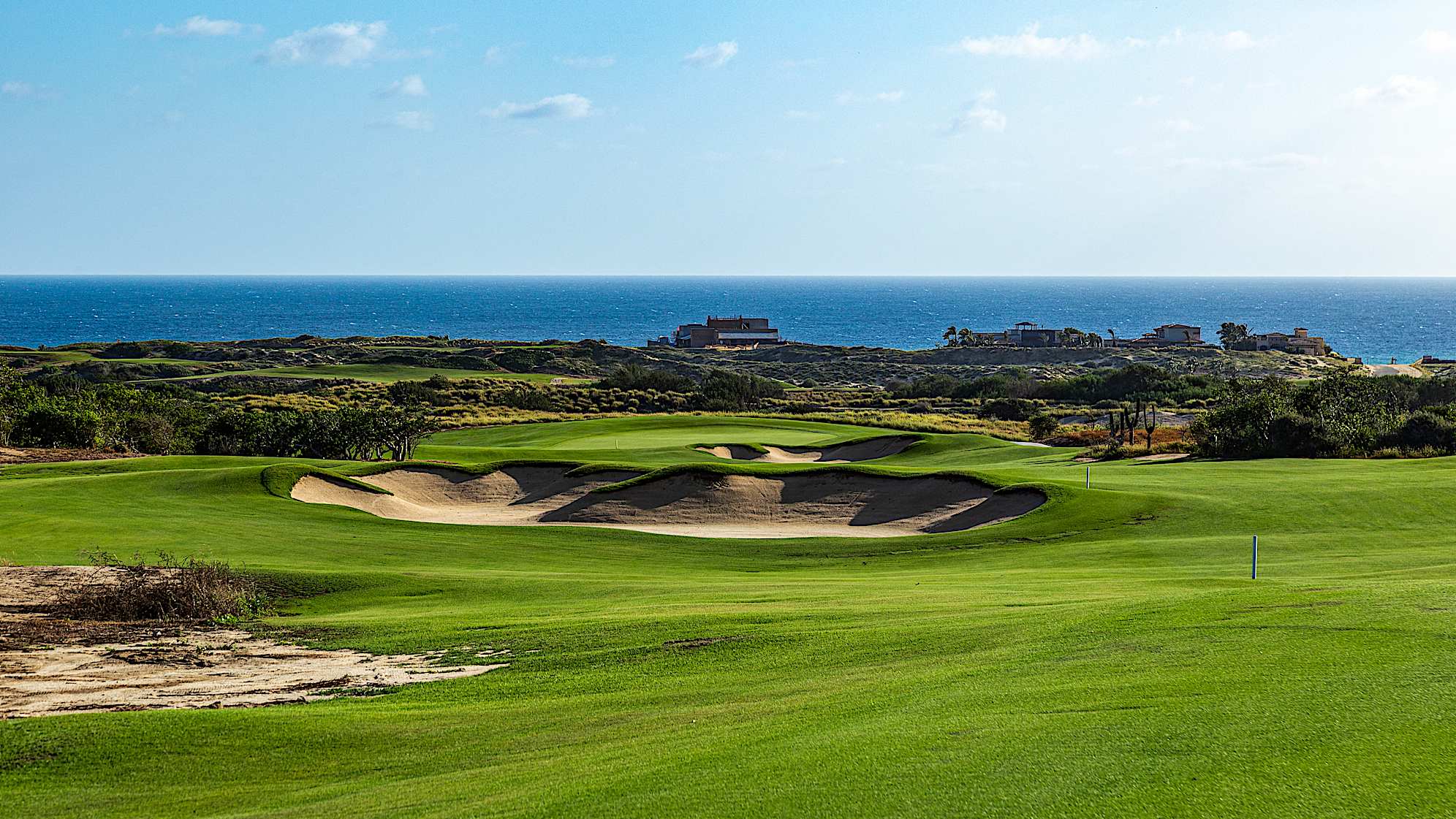 This downhill, lengthy par 4 offers expansive views of the Pacific Ocean. A tee shot carrying the left fairway bunker sets up an unobstructed approach to the green. Shots veering too far right contend with a bunker short of the green. A generous feeder slope short of the green aids in propelling balls onto the putting surface, while low chipping areas protect both flanks of the contoured green.