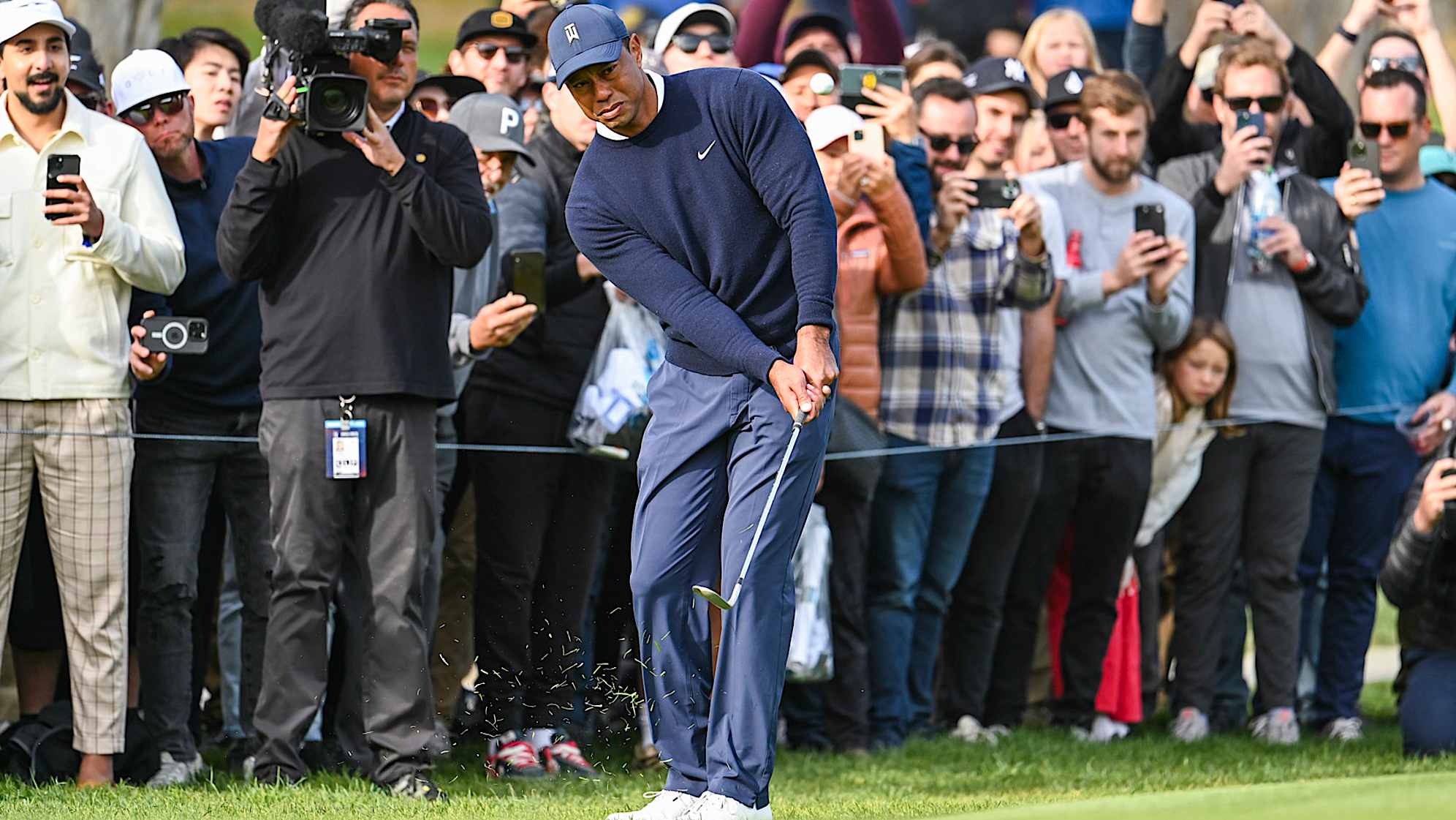 PACIFIC PALISADES, CA - FEBRUARY 16:  Fans watch as Tiger Woods chips a shot to the 12th hole green during the first round of the Genesis Invitational at Riviera Country Club on February 16, 2023 in Pacific Palisades, California. (Photo by Keyur Khamar/PGA TOUR via Getty Images)