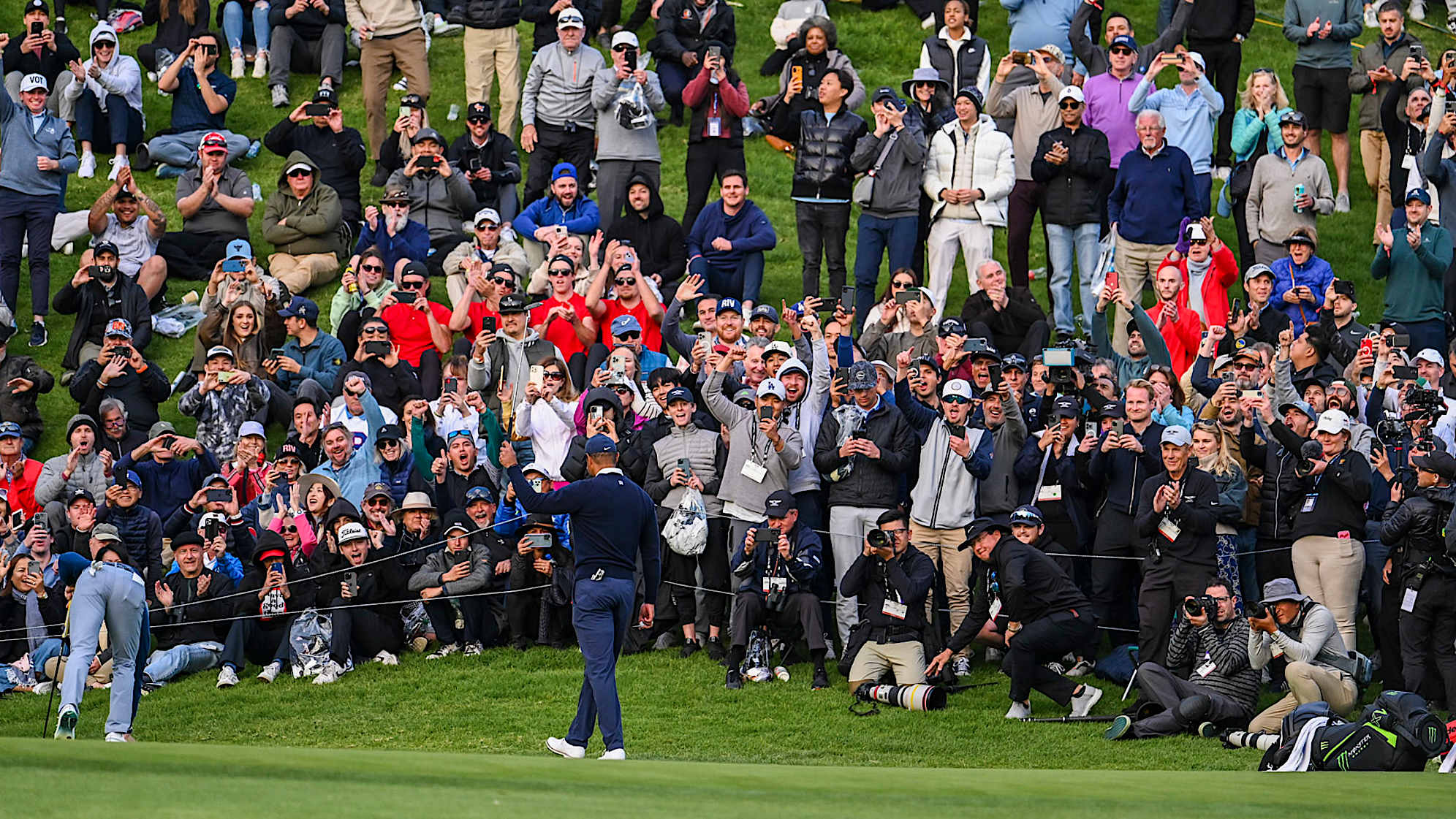 PACIFIC PALISADES, CA - FEBRUARY 16:  Fans celebrate as Tiger Woods makes a birdie putt on the 18th hole green during the first round of the Genesis Invitational at Riviera Country Club on February 16, 2023 in Pacific Palisades, California. (Photo by Keyur Khamar/PGA TOUR via Getty Images)