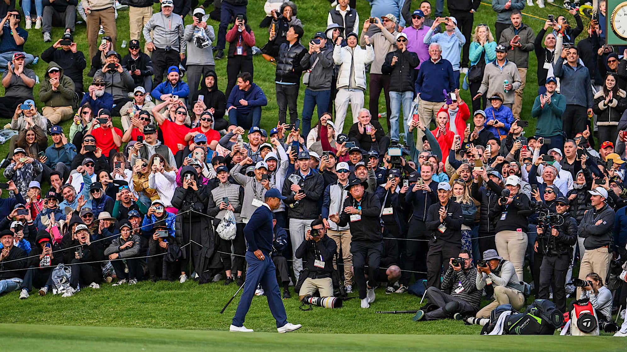 PACIFIC PALISADES, CA - FEBRUARY 16:  Fans celebrate as Tiger Woods makes a birdie putt on the 18th hole green during the first round of the Genesis Invitational at Riviera Country Club on February 16, 2023 in Pacific Palisades, California. (Photo by Keyur Khamar/PGA TOUR via Getty Images)