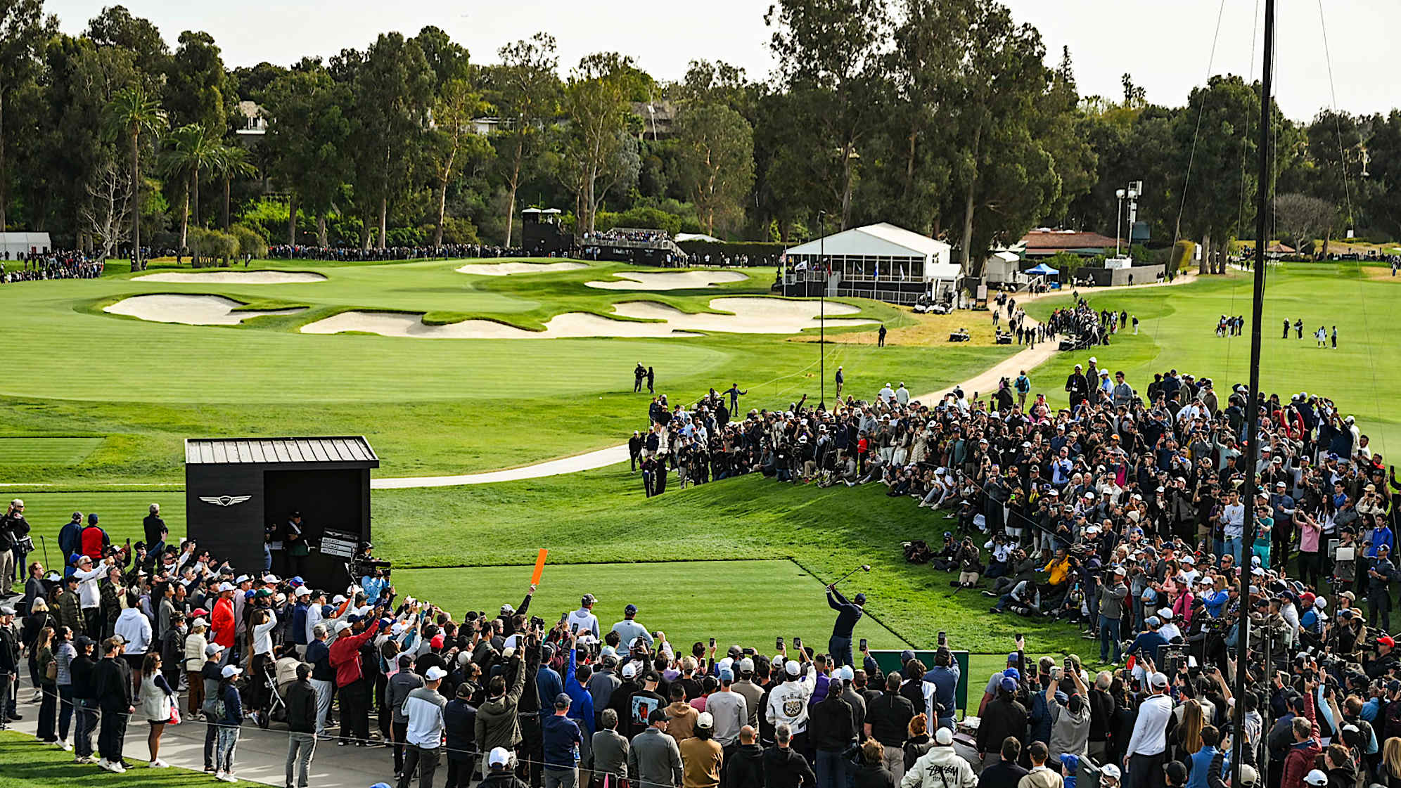 PACIFIC PALISADES, CA - FEBRUARY 16:  Fans watch and record with their mobile phones as Tiger Woods plays his shot from the 10th tee during the first round of the Genesis Invitational at Riviera Country Club on February 16, 2023 in Pacific Palisades, California. (Photo by Keyur Khamar/PGA TOUR via Getty Images)