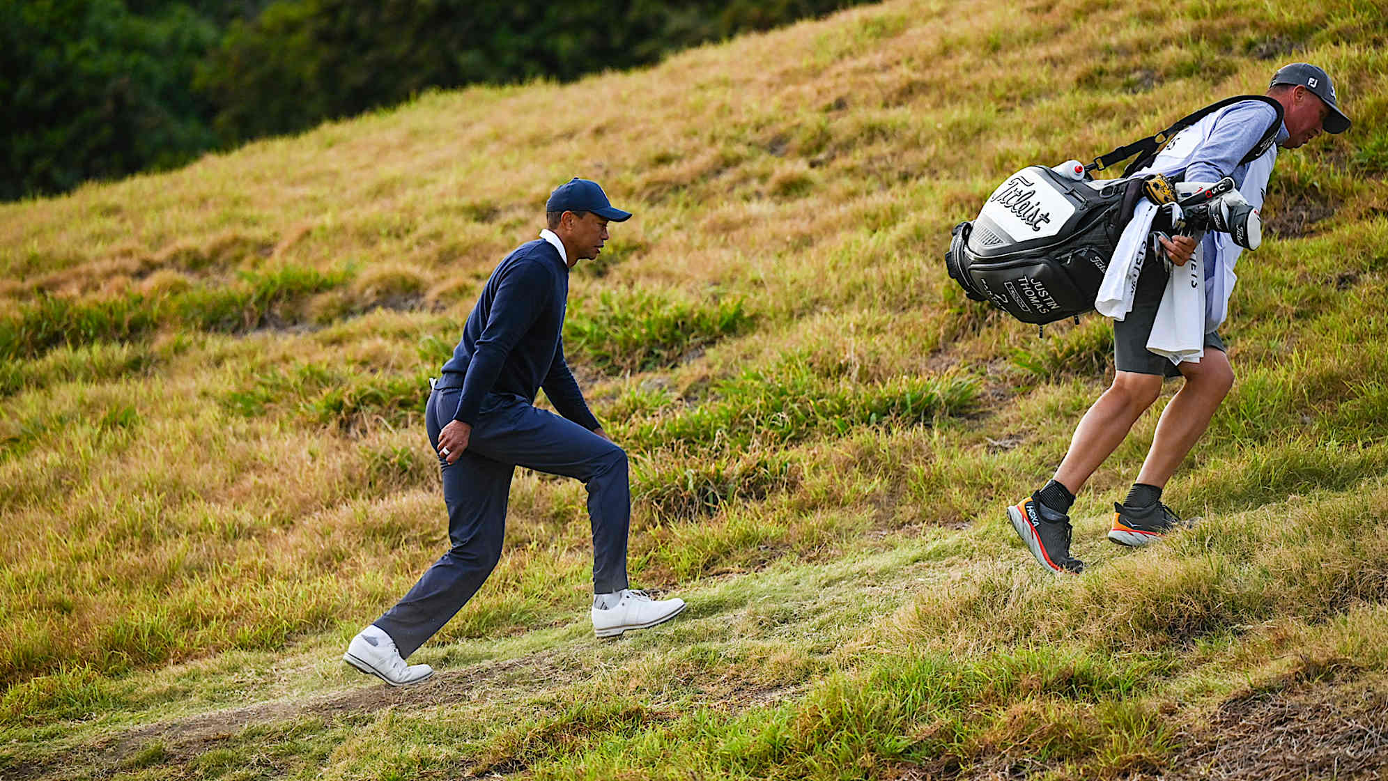PACIFIC PALISADES, CA - FEBRUARY 16:  Tiger Woods walks up the hill to the 18th hole fairway during the first round of the Genesis Invitational at Riviera Country Club on February 16, 2023 in Pacific Palisades, California. (Photo by Keyur Khamar/PGA TOUR via Getty Images)