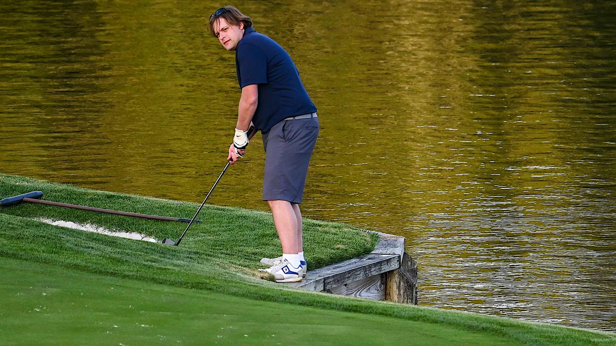A golfer stands on the bulkhead before playing a shot on the 17th hole on the Stadium Course at TPC Sawgrass, home of THE PLAYERS Championship, on January 20, 2023 in Ponte Vedra Beach, Florida. (Photo by Keyur Khamar/PGA TOUR via Getty Images)