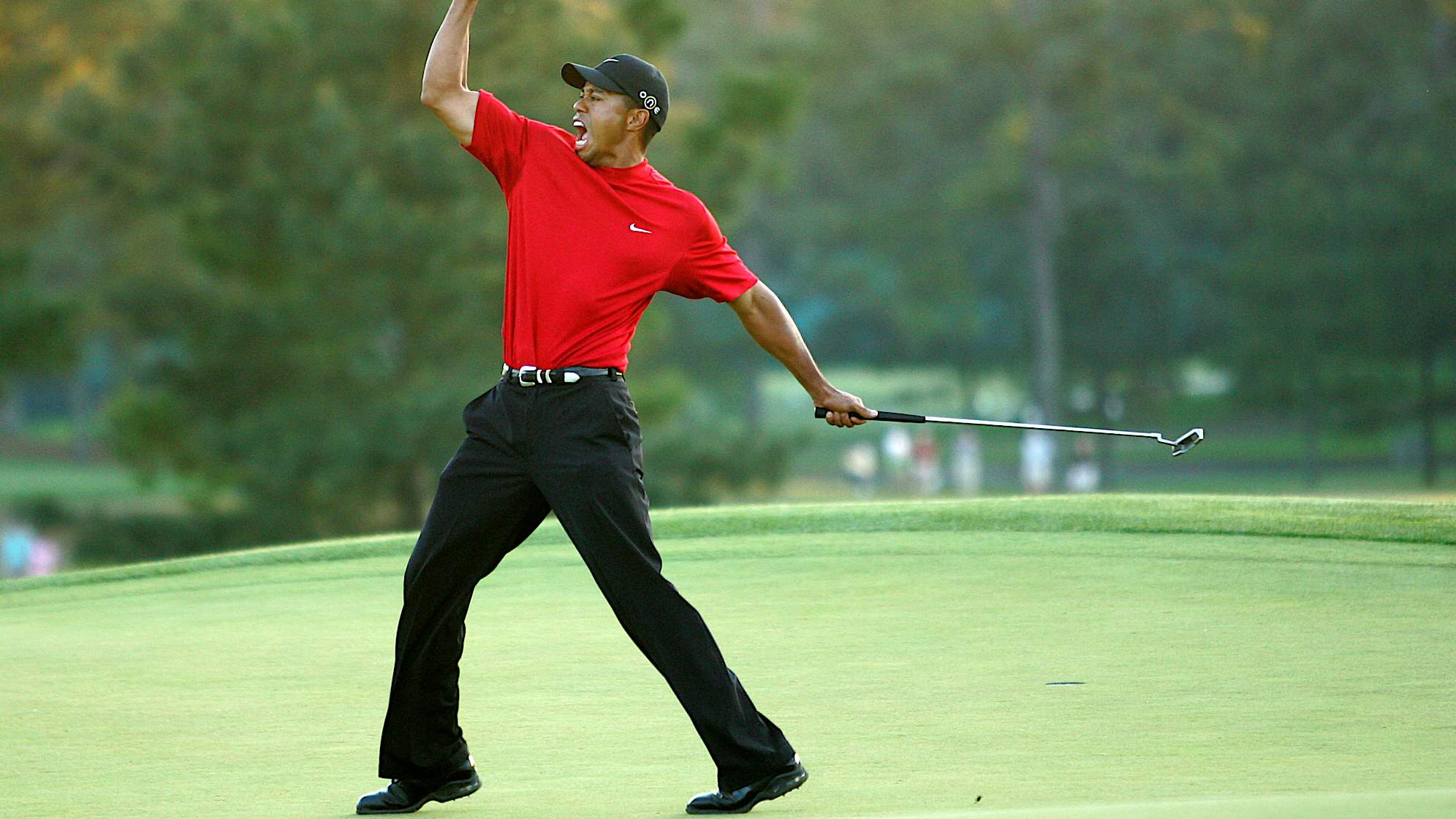 AUGUSTA, GA - APRIL 10:  Tiger Woods celebrates after sinking a putt on the first playoff hole to win the 2005 Masters on April 10, 2005 at Augusta National Golf Course in Augusta, Georgia.  (Photo By Getty Images)