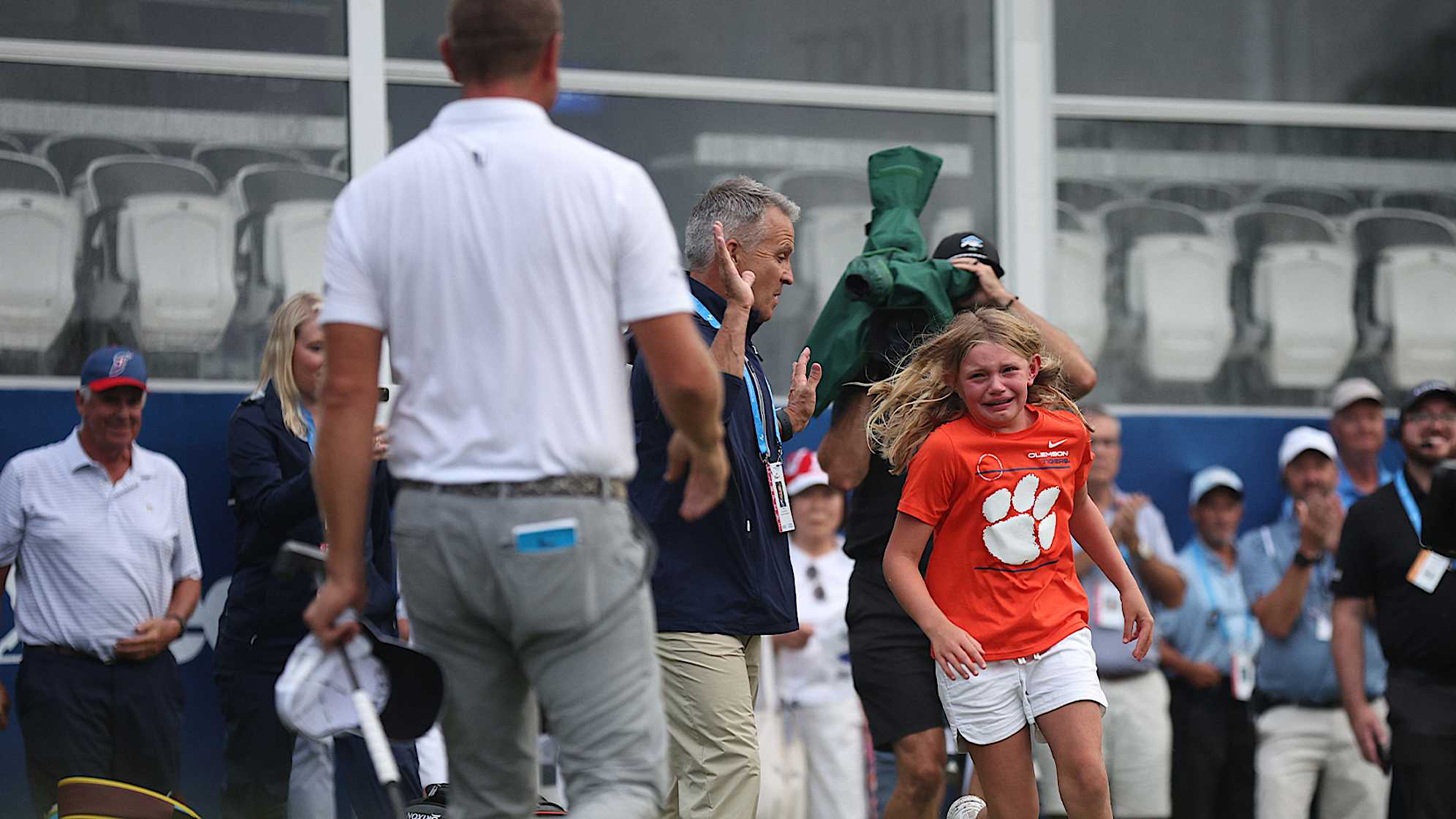Lucas Glover's daughter runs to him on the 18th green at Sedgefield Country Club. (Jared C. Tilton/Getty Images)