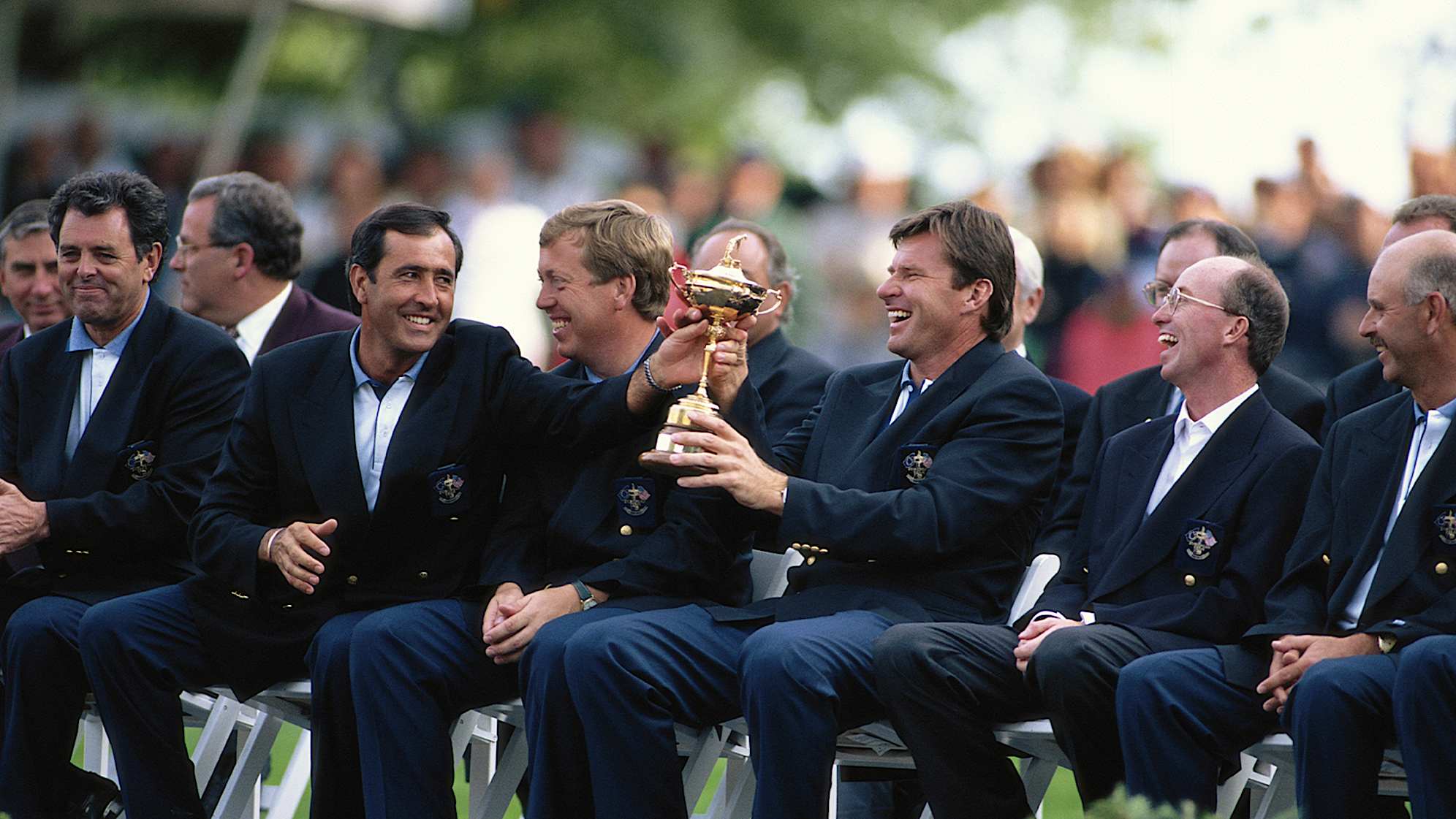 Seve Ballesteros shares a laugh with Sir Nick Faldo while both hold the trophy after the 1995 Ryder Cup at Oak Hill Country Club. (Simon Bruty/Getty Images)