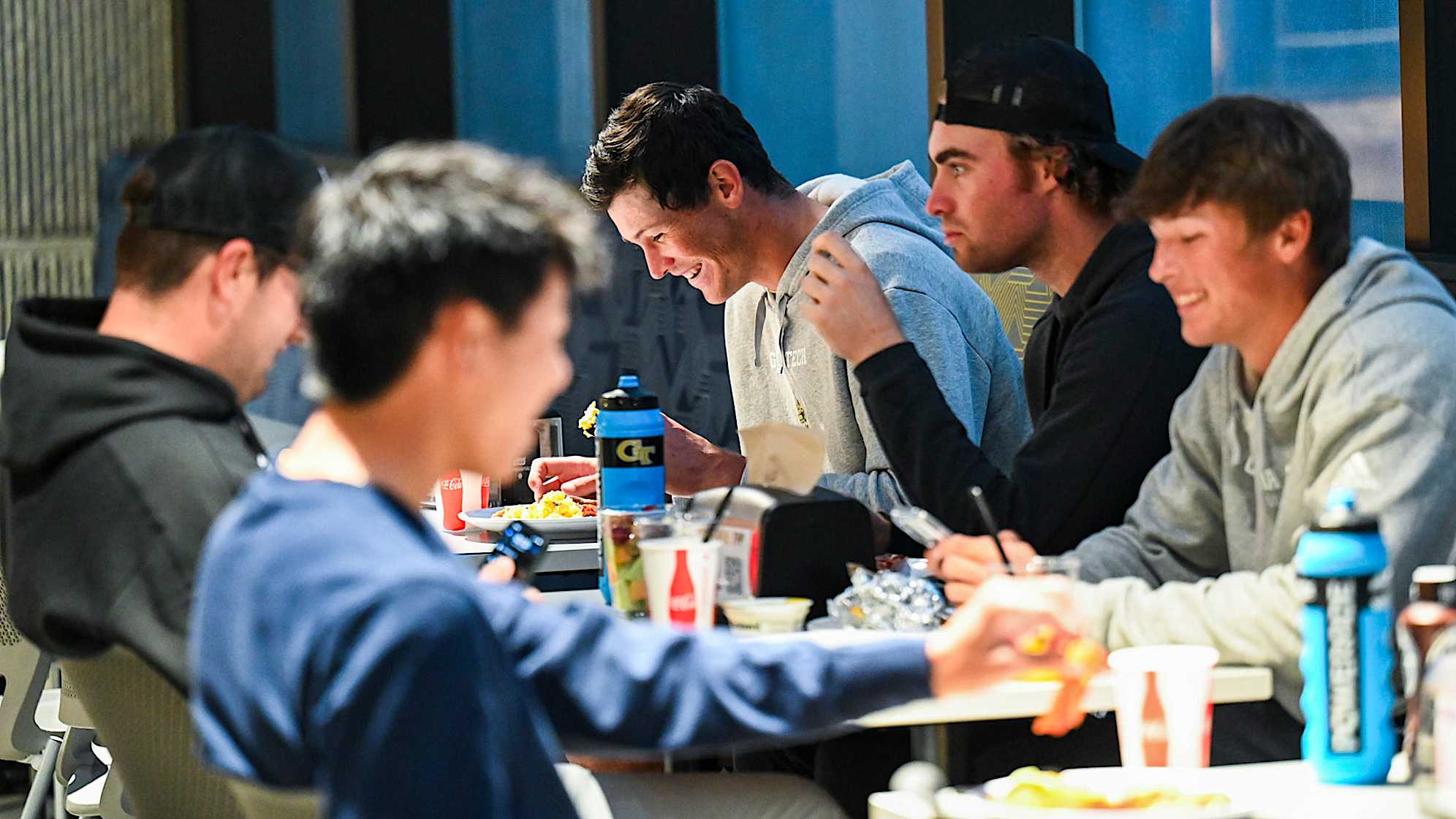 ATLANTA, GEORGIA - NOVEMBER 02:  Christo Lamprecht of South Africa eats breakfast with his golf teammates in the Hugh Spruill Strength Center during a PGA TOUR University shoot at the Georgia Institute of Technology on November 2, 2023 in Atlanta, Georgia. (Photo by Keyur Khamar/PGA TOUR)