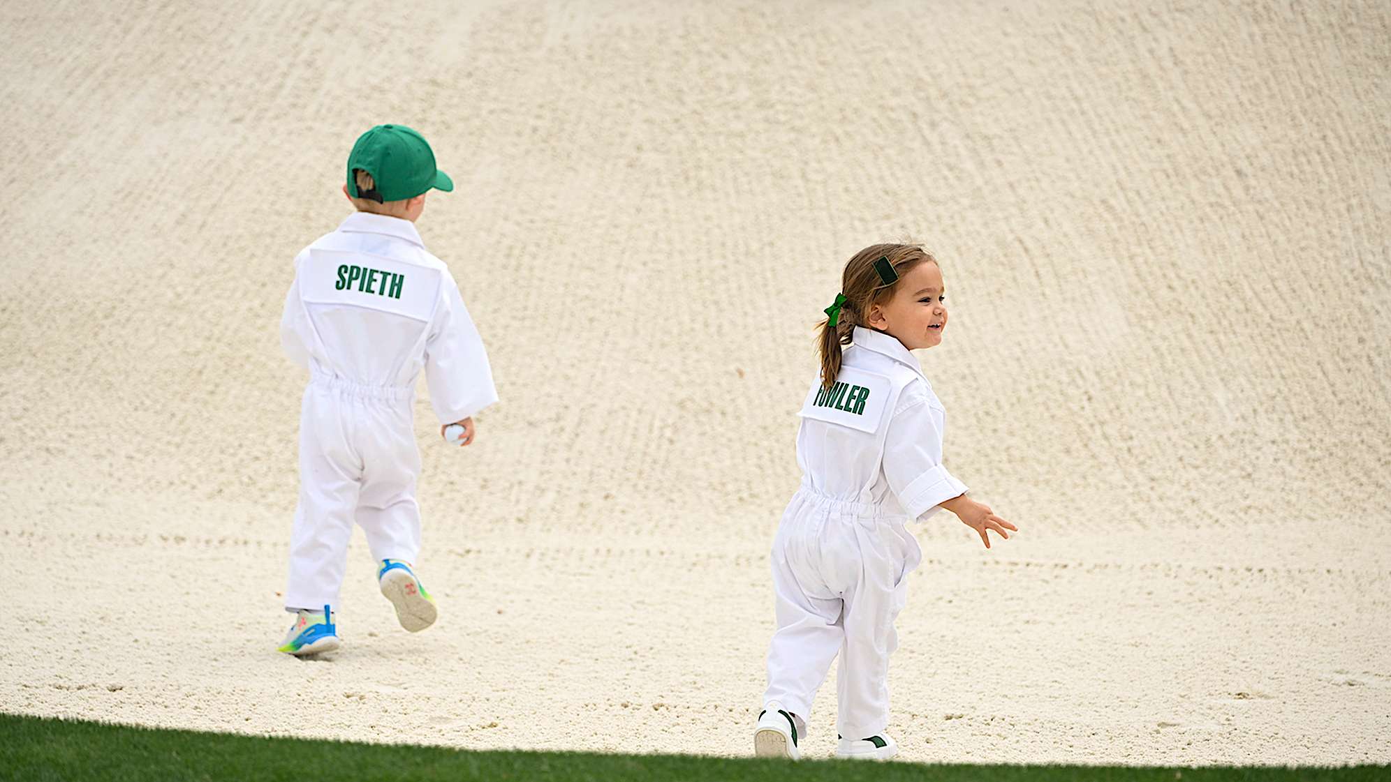 Sammy Spieth and Maya Fowler play in a bunker during the Masters Par 3 Contest. (Ben Jared/PGA TOUR)
