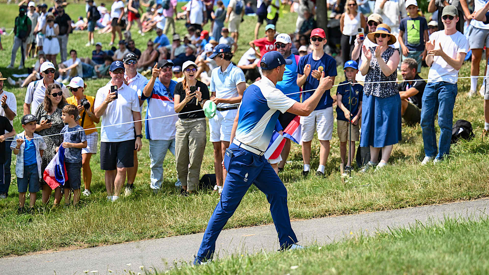 Victor Perez of Team France gives a thumbs up to French fans after making a birdie putt on the 18th hole green during the first round of the Olympic men’s golf competition. (Keyur Khamar/PGA TOUR)