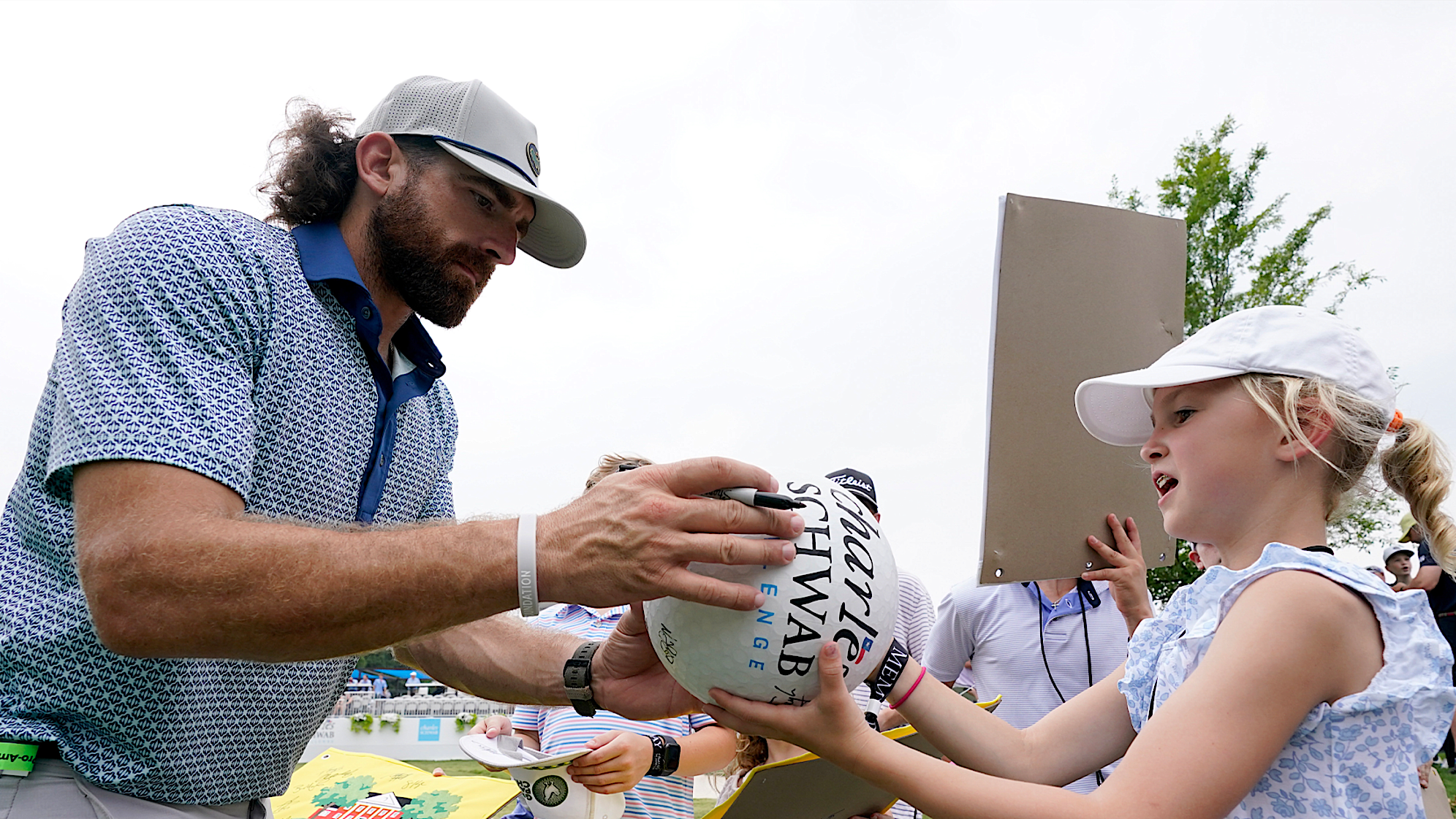Tyler Toney of Dude Perfect signs autographs during a practice prior to the 2024 Charles Schwab Challenge at Colonial Country Club. (Sam Hodde/Getty Images)