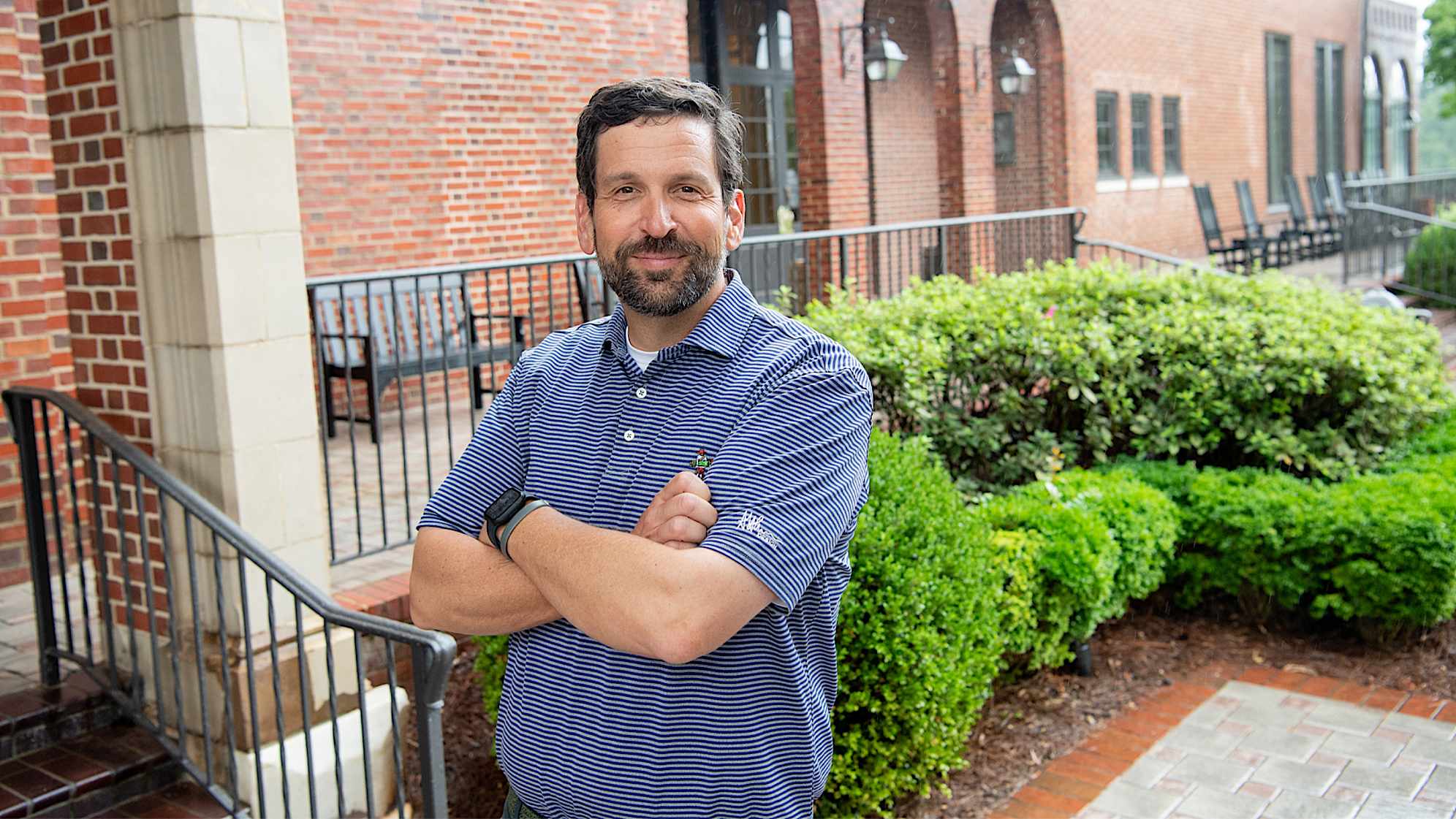 Andrew Green, the architect behind the East Lake renovation, posing in font of the clubhouse. (Kate Awtrey)