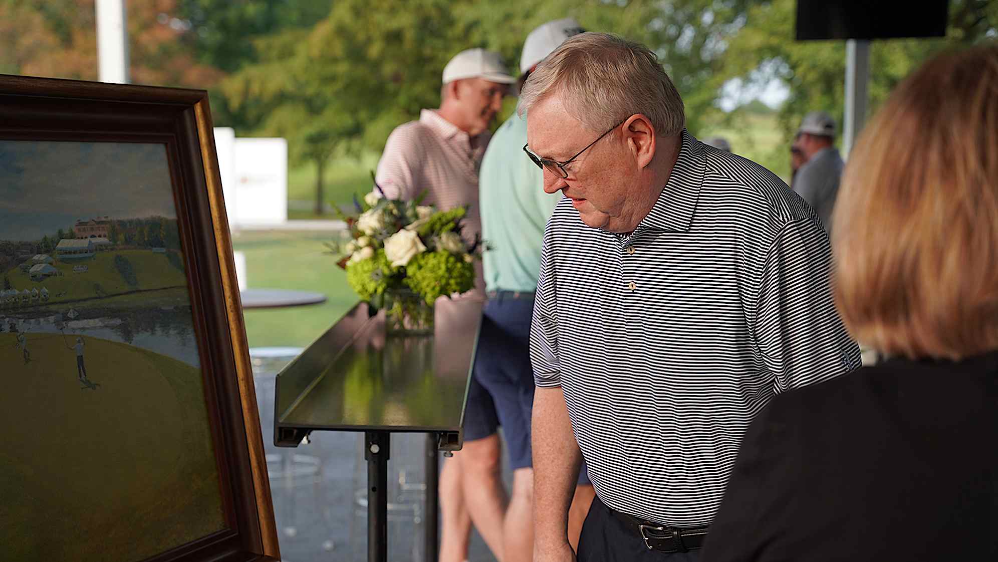 Eric Murray looks at the portrait that commemorates his son Grayson's win at the 2023 Simmons Bank Open. (Devon Reagan/PGA TOUR)                               
