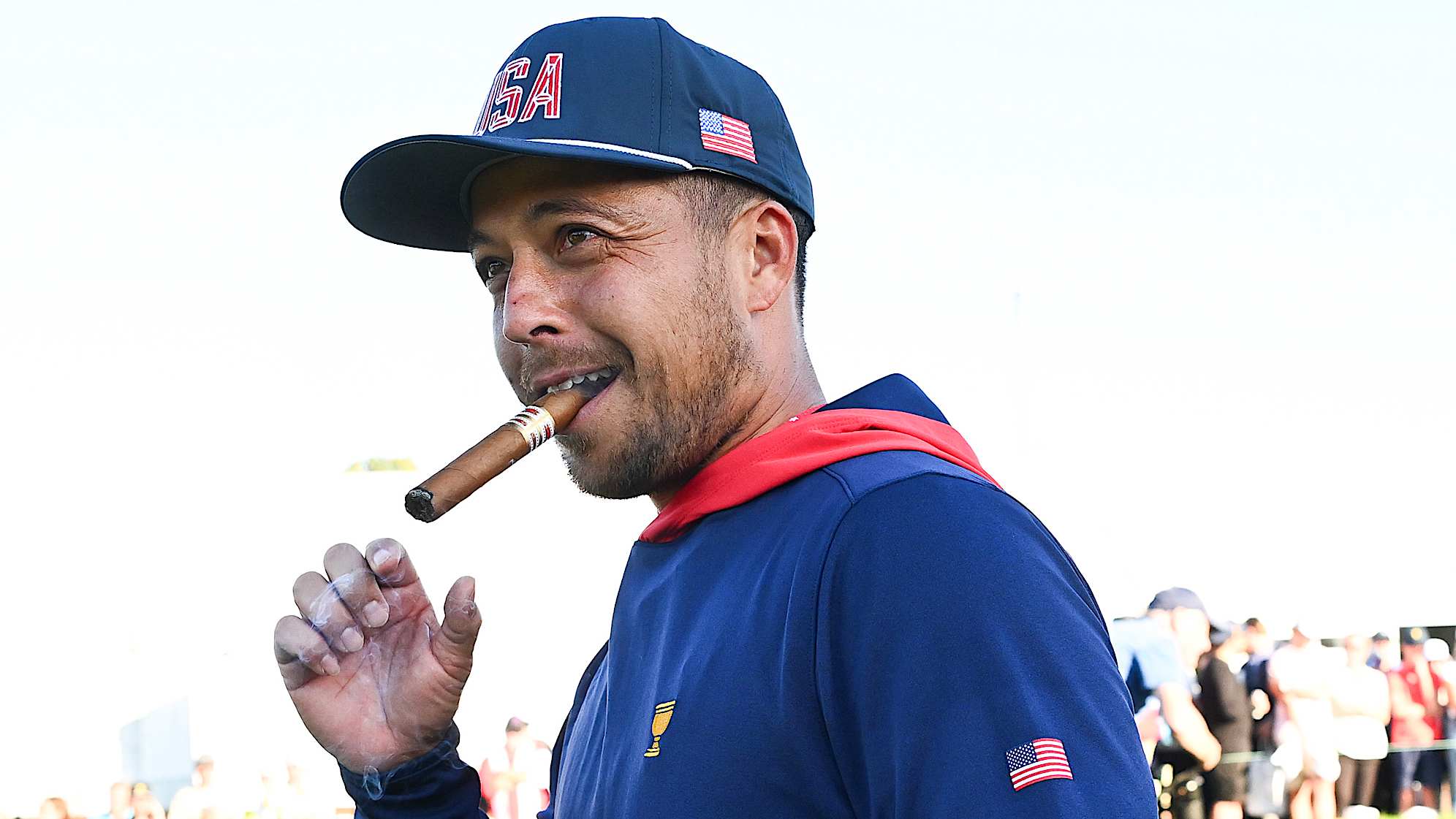 Xander Schauffele lighting up his signature cigar after he and his team were victorious in Montreal, Canada, for the 2024 Presidents Cup.