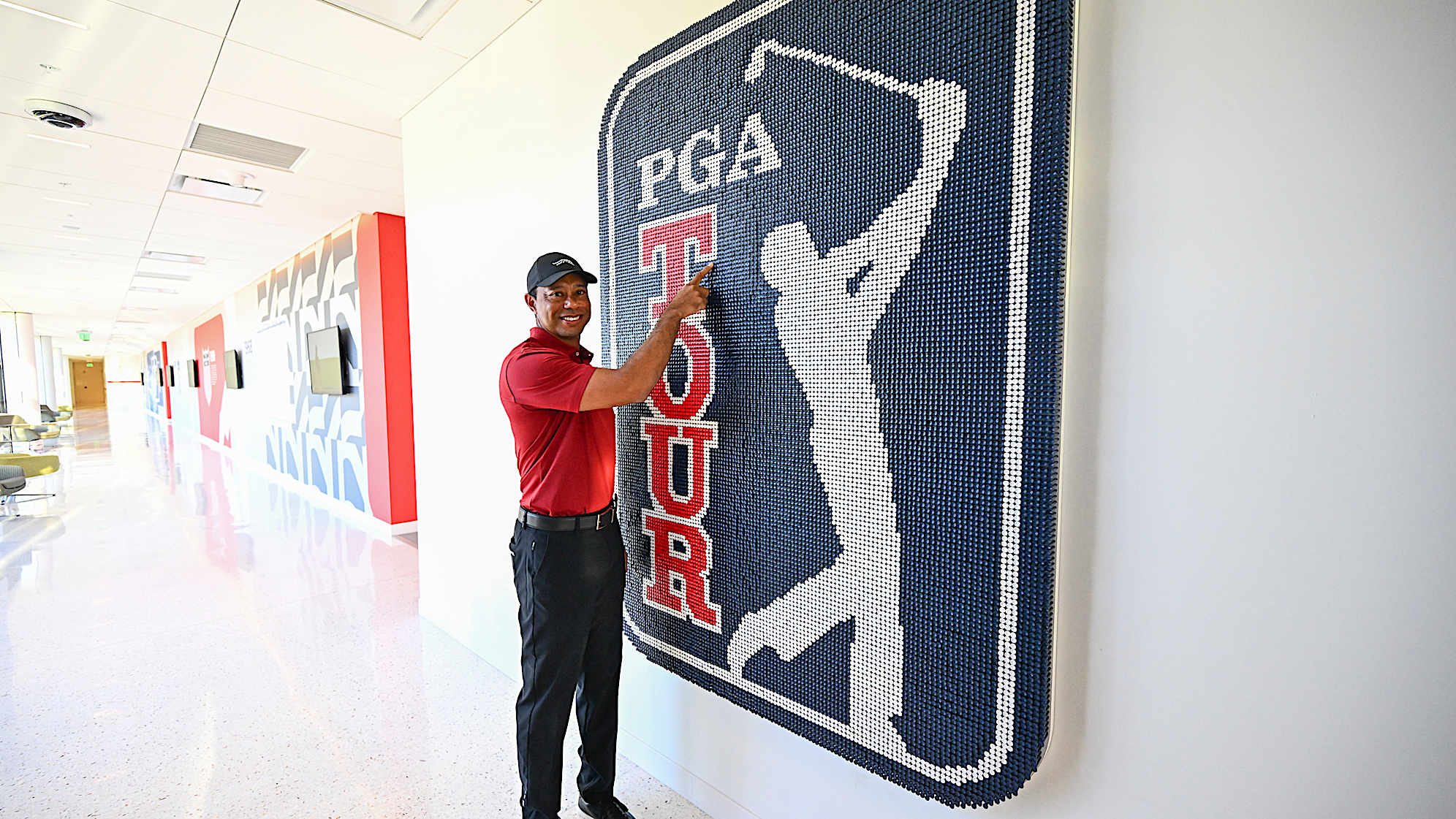 Tiger Woods adds a tee to an art installation at PGA TOUR Studios at the PGA TOUR Global Home campus on Nov. 18, 2024, in Ponte Vedra Beach, Florida. (Chris Condon/PGA TOUR)