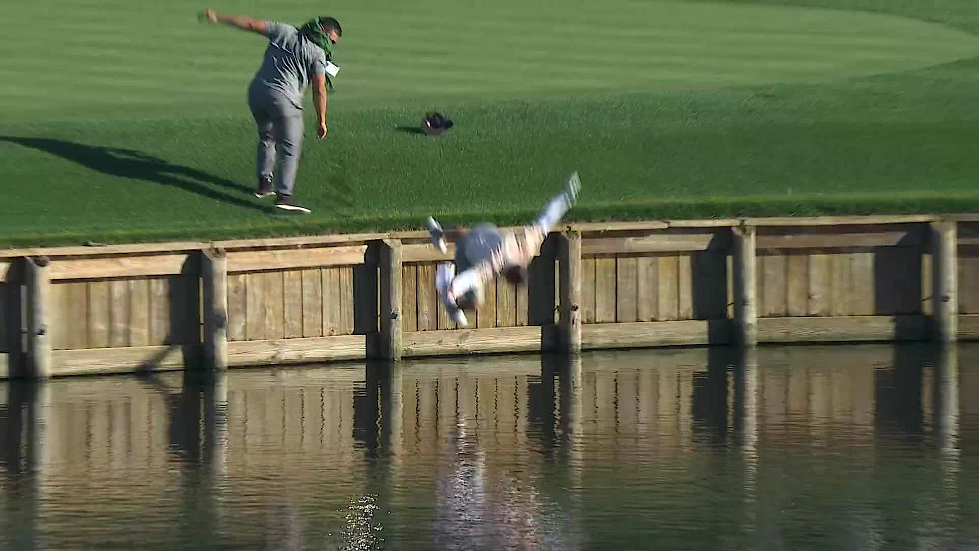 Alejandro Tosti jumps in the water after acing the 17th hole at TPC Sawgrass. (Courtesy PGA TOUR)