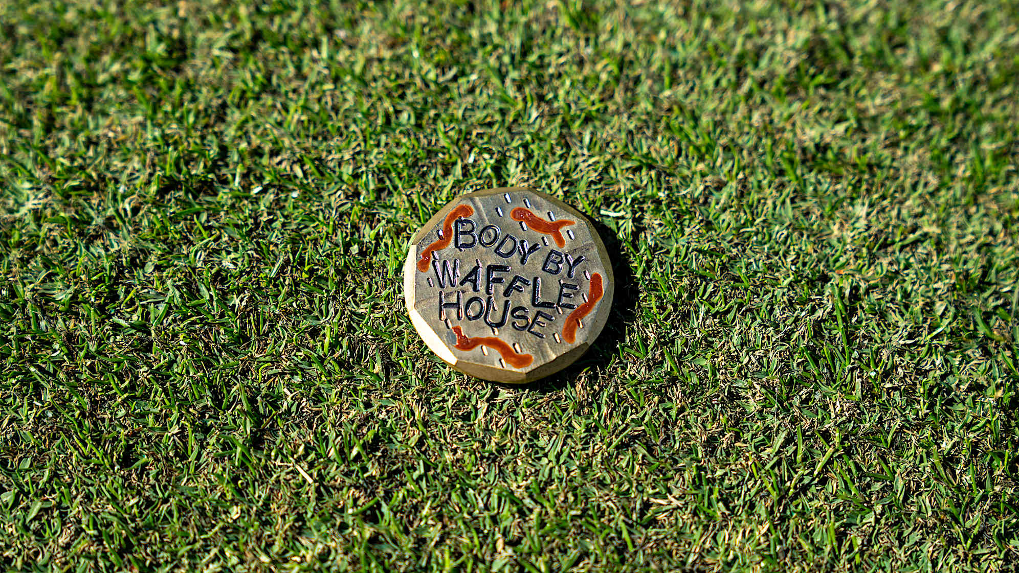 A look at Neal Shipley's "Body by Waffle House" ball marker. (Bret Clein/PGA TOUR)