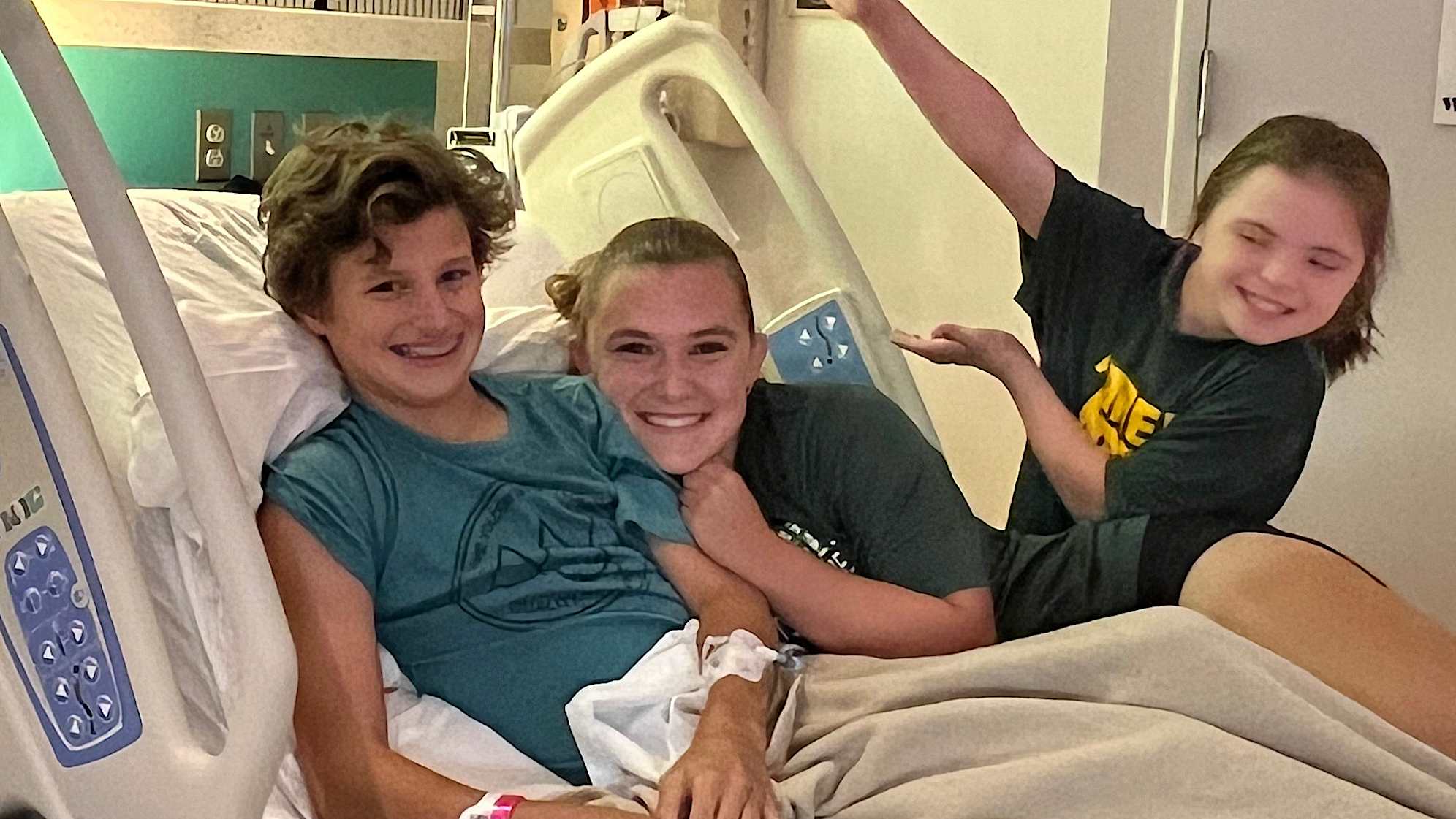 Andrew Ross (left) with his sisters. (Courtesy Ross family)