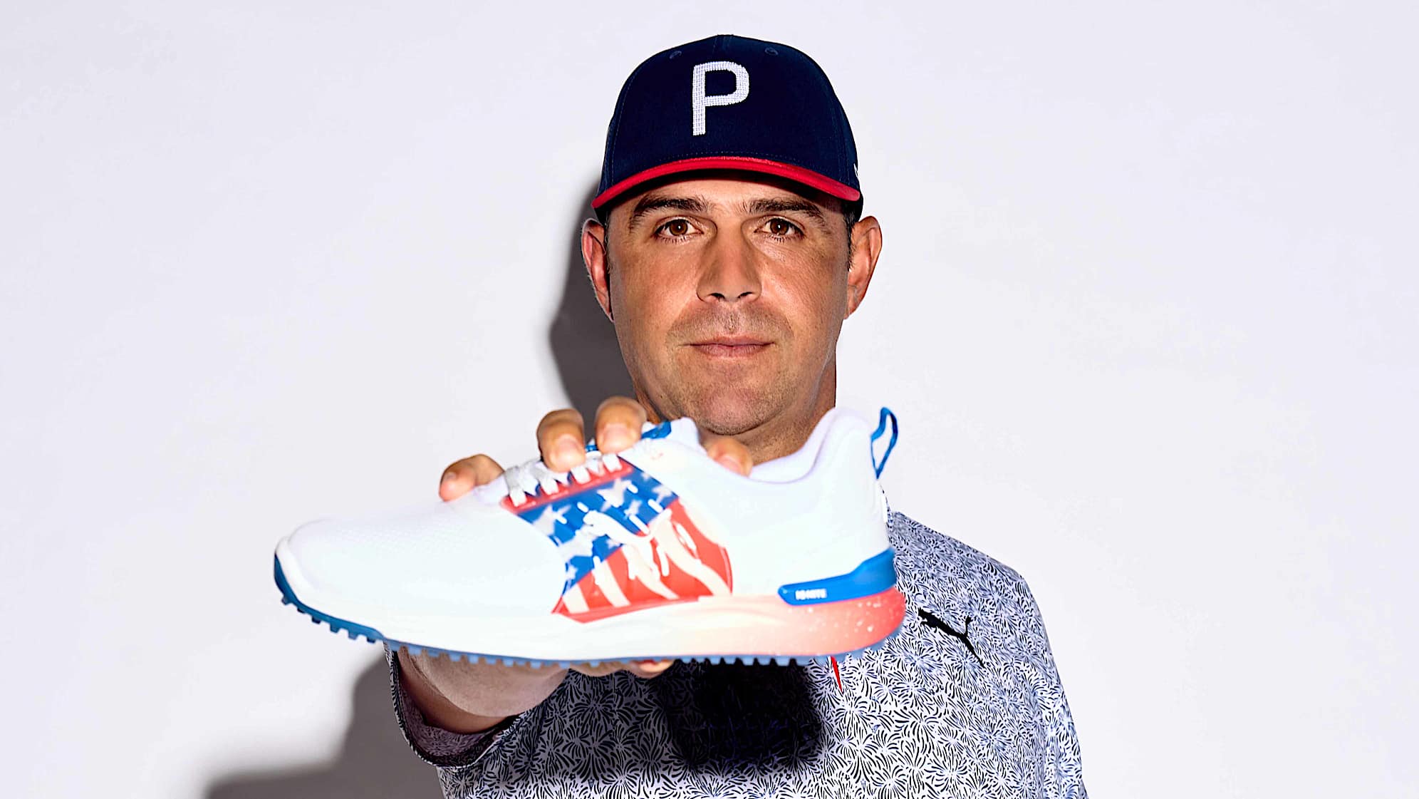 Gary Woodland poses with one of PUMA Golf's new spikeless IGNITE ELEVATE shoe. (Courtesy PUMA Golf)