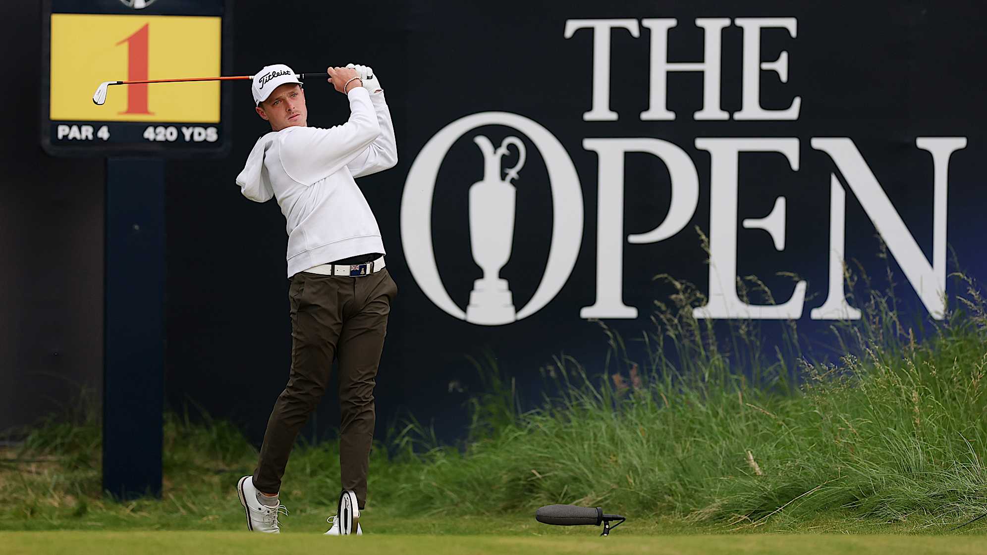 PORTRUSH, NORTHERN IRELAND - JULY 17: Amateur, Justin Hastings of the Cayman Islands tees off on the first hole during day one of The 153rd Open Championship at Royal Portrush Golf Club on July 17, 2025 in Portrush, Northern Ireland. (Photo by Andrew Redington/Getty Images)