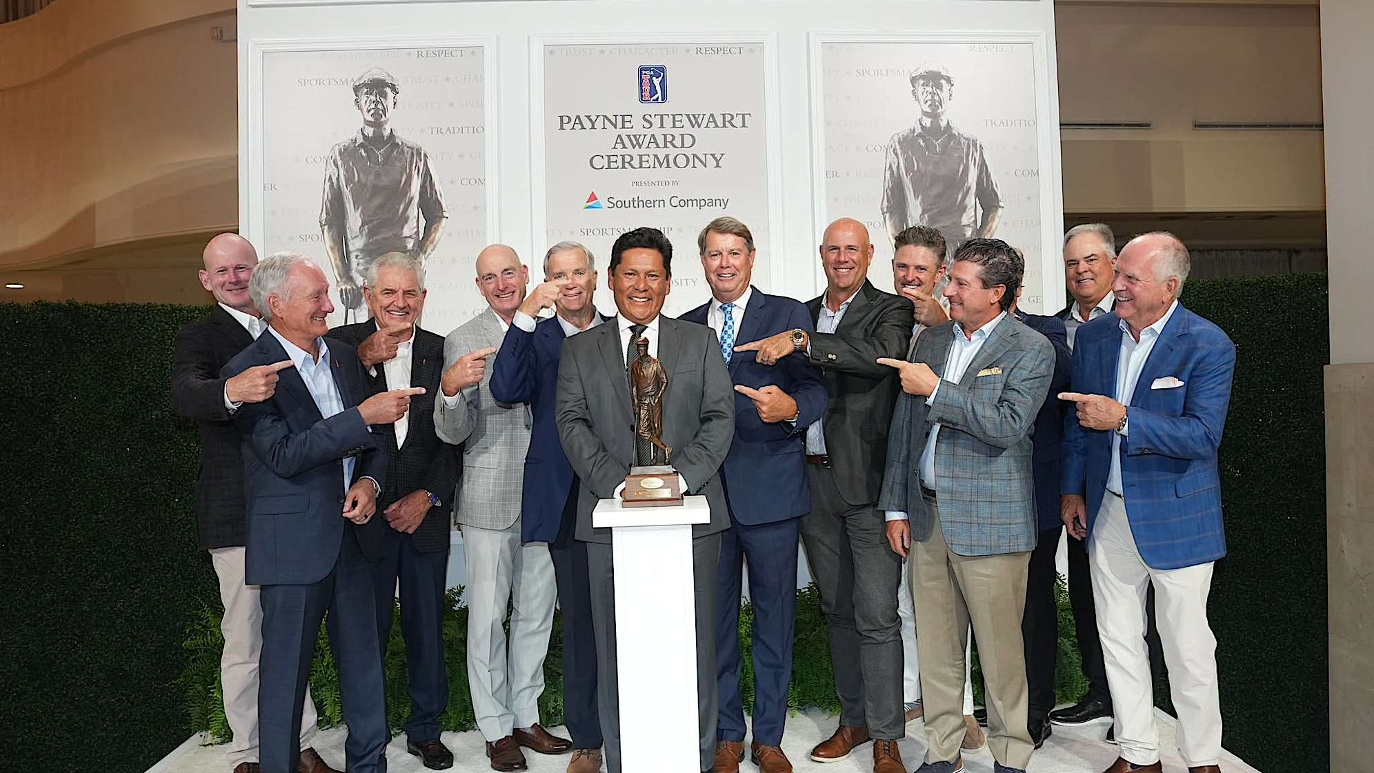 Notah Begay III poses with the trophy and past recipients during the Payne Stewart Award Ceremony prior to the 2026 TOUR Championship. (Ben Jared/PGA TOUR via Getty Images)