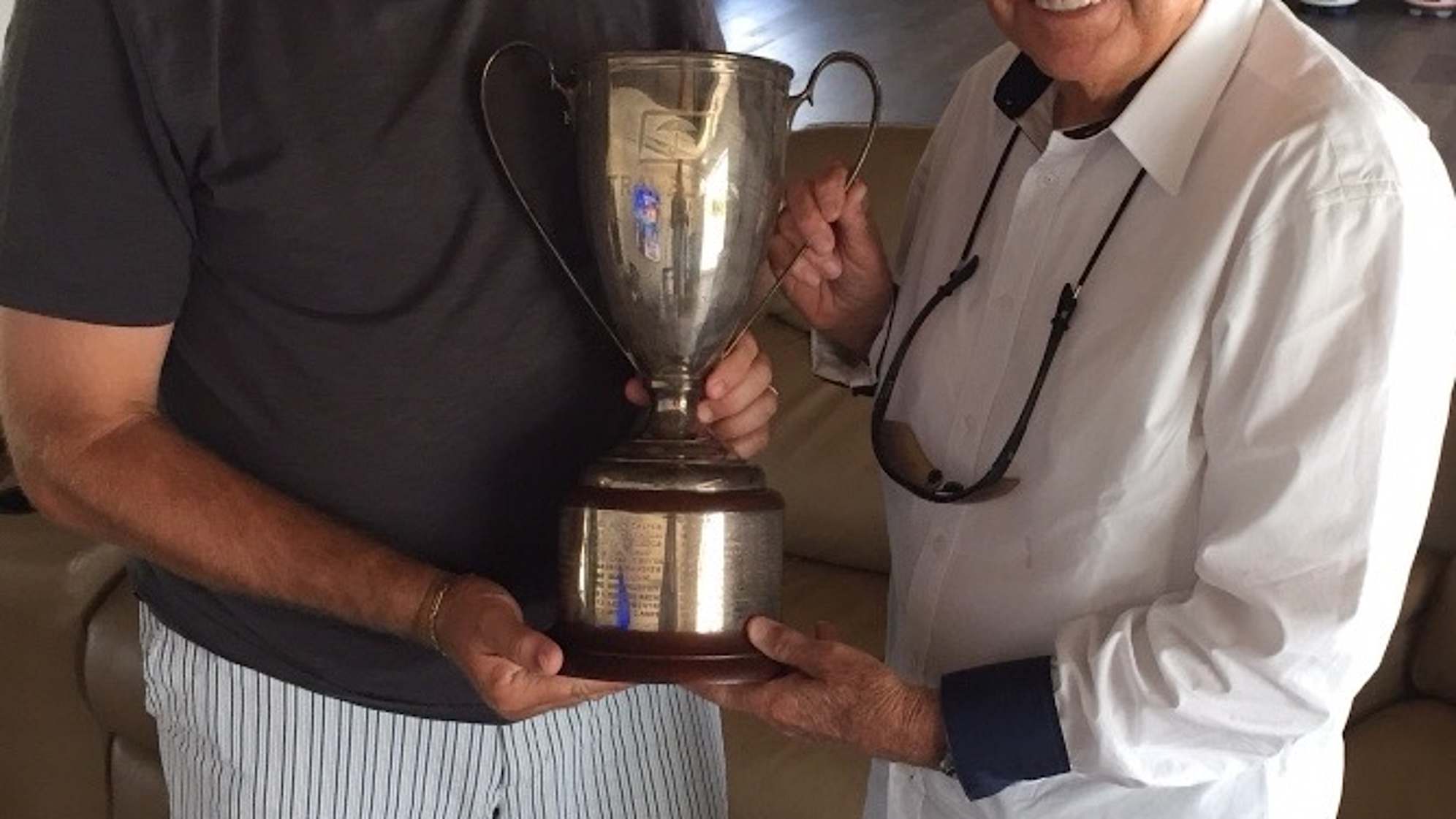 Ken Duke and coach Bob Toski hold the Travelers Championship trophy after Duke's first PGA Tour win at TPC River Highlands in 2013. (Courtesy of Ken Duke)