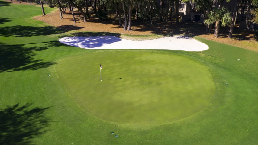 A straight drive is imperative to stay between overhanging branches in a chute only 20 yards wide, but the fairway opens up at the landing area. A short or medium iron should reach a green protected by both sand and grass bunkers.