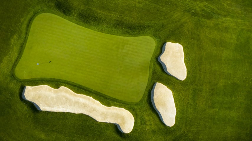 The shortest of the par 3 holes at Oak Hill is no walk in the park. Short and left are deep bunkers that will make for a difficult up-and-down should the player find them off the tee. A tightly mown run-off area right of the green drops off dramatically in elevation, leaving the player with a tough shot from a very tight lie to this multi-tiered green. (Source: PGA of America)