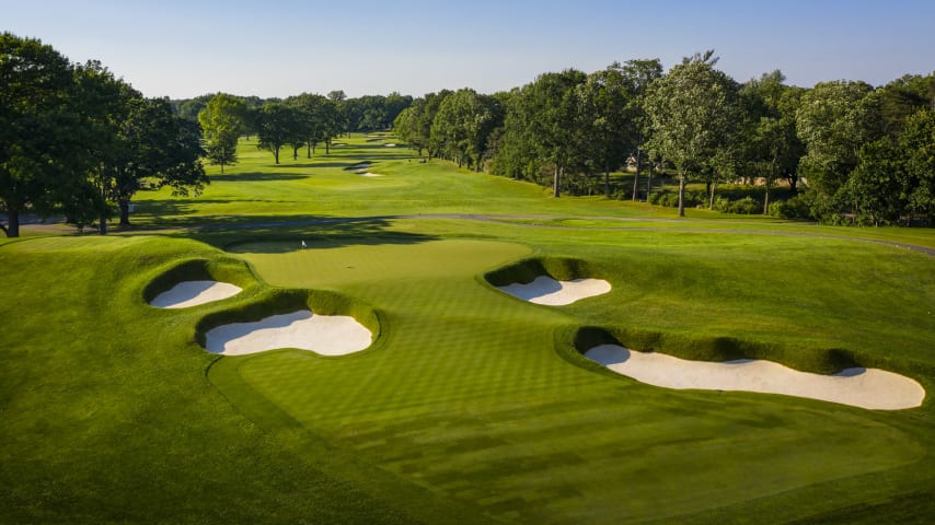 The first par 3 requires a shot with a mid or long iron to a green that slopes predominately from back to front. Three deep bunkers guard the green in front. A ball that lands on the front third of the green has a minimal chance of staying on due to an aggressive false front. (Source: PGA of America)