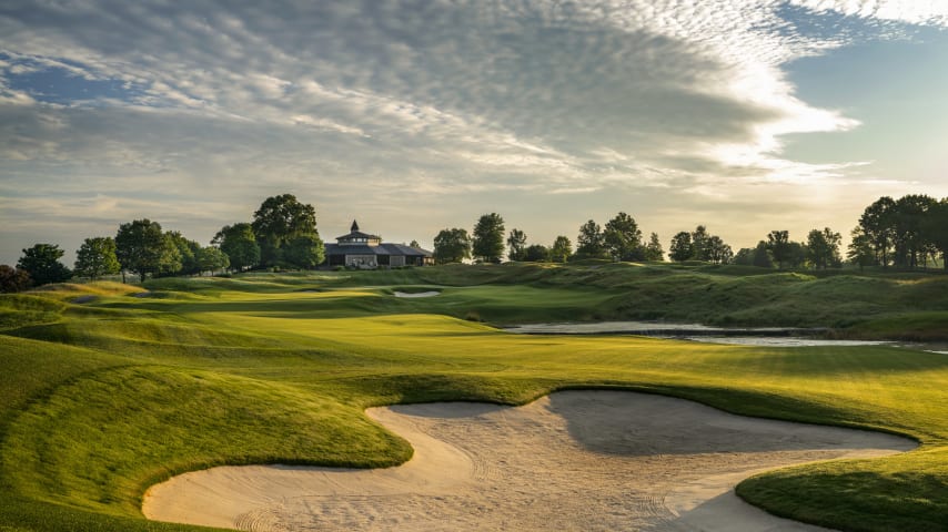 Photo Finish: This epic finishing hole bends gracefully to the right, with a large bunker to the left of the landing zone and a beautiful water feature on the right. Most players can get home in two, but will have to contend with a big bunker in front and a smaller pot bunker left. The vast, horseshoe-shaped green has distinct putting areas left, center, and right, so simply getting on the surface is no guarantee of a good score. (Source: PGA of America)