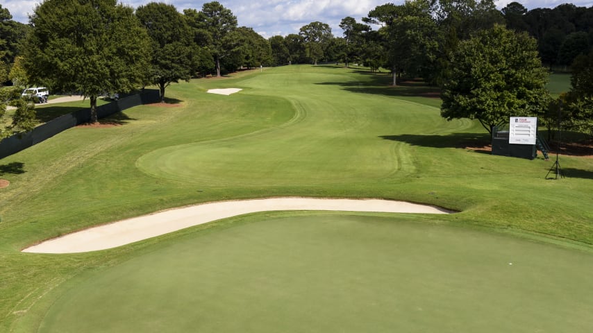Most players will hit fairway woods or long irons off the tee on this downhill par 4. An overhanging tree and deep rough on the left side of the fairway make this hole very tough from the left side. The right center of the fairway is the ideal location, leaving a short iron to the green.