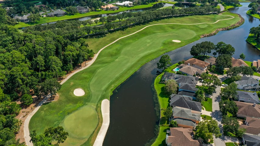 This dogleg left hole features two potential teeing areas offering different experiences. From the elevated teeing area, all of the hole's hills and valleys are visible before a tee shot which needs to favor the right-center of the fairway to take advantage of the right-to-left slope. From the lower tee, a more aggressive, direct line can be taken without risking the tee shot bouncing left and into the water. A long, thin bunker protects the left side of this multi-tiered green and may also protect a wayward approach shot from ending up in the water.