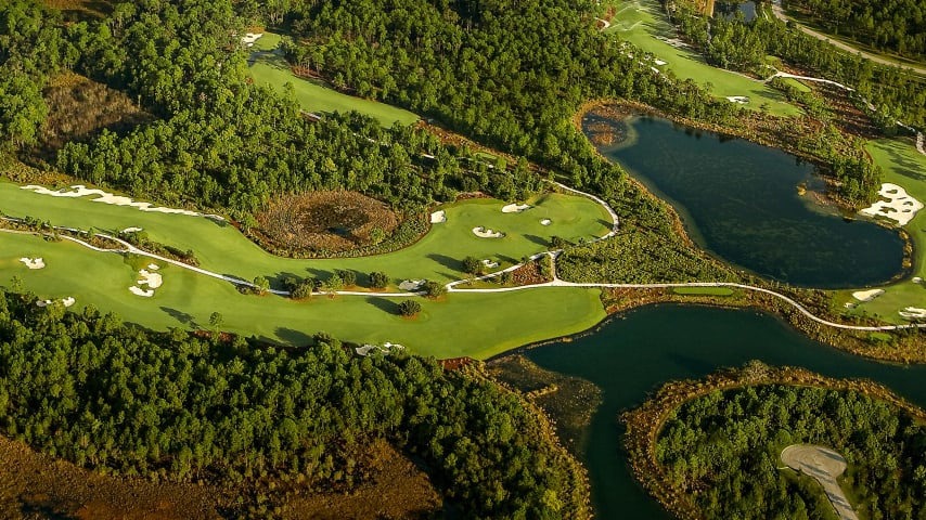 The fairway slopes from right to left, which will help you work your drive off the fairway bunker straight ahead. The second shot is over a wetland area.