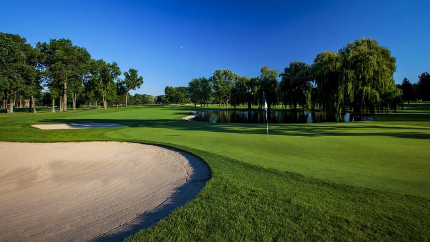 A classic risk-reward par 5. The 14th will see a majority of players approaching it as a two-shot hole with long hitters only having a mid-to-long iron approach shot into this two-tiered green guarded by water in front. Those who elect to lay up on their second will need to control the spin on their shots due to a false front on the left side of the green.