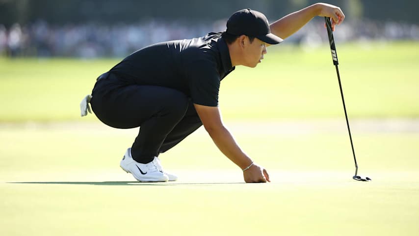 MONTREAL, QUEBEC - SEPTEMBER 29: Tom Kim of South Korea and the International Team lines up a putt on the 15th green during Sunday Singles on day four of the 2024 Presidents Cup at The Royal Montreal Golf Club on September 29, 2024 in Montreal, Quebec, Canada. (Photo by Jared C. Tilton/Getty Images)