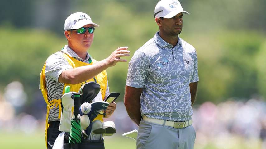 Aaron Rai of England speaks with Caddie Jason Timmis before his second shot on the second hole during the third round of the PGA Championship at Quail Hollow Country Club on May 17, 2025 in Charlotte, North Carolina. (Andrew Redington/Getty Images)