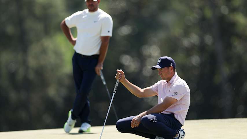 Jordan Spieth of the United States lines up a putt as Brooks Koepka of the United States looks on from the 18th green during the second round of the 2026 Masters Tournament at Augusta National Golf Club on April 10, 2026 in Augusta, Georgia. (Maddie Meyer/Getty Images)