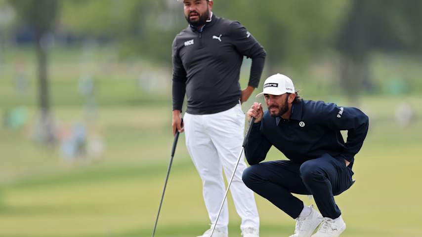 Max Homa of the United States and J.J. Spaun of the United States lines up a putt on the 16th green during the second round of the PGA Championship at Aronimink Golf Club on May 15, 2026 in Newtown, Pennsylvania. (Michael Reaves/Getty Images)