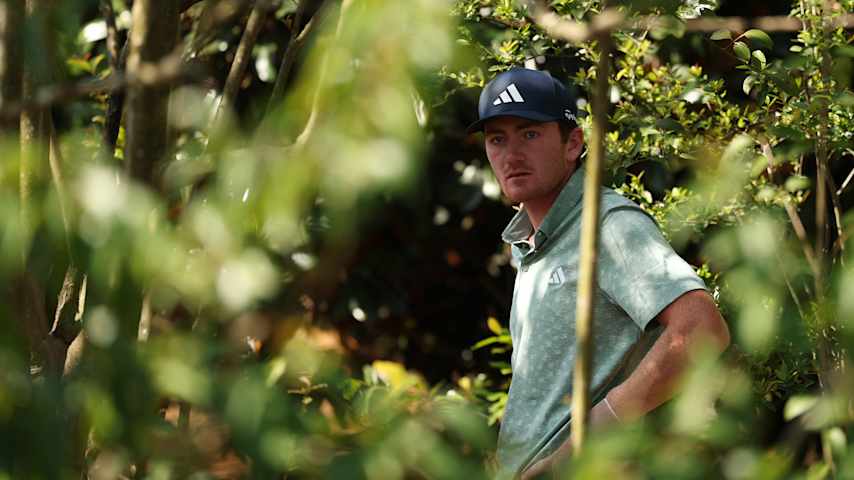 Nick Dunlap of the United States prepares to play a shot from the trees on the fifth hole during the first round of the 2025 Masters Tournament at Augusta National Golf Club on April 10, 2025 in Augusta, Georgia. (Richard Heathcote/Getty Images)