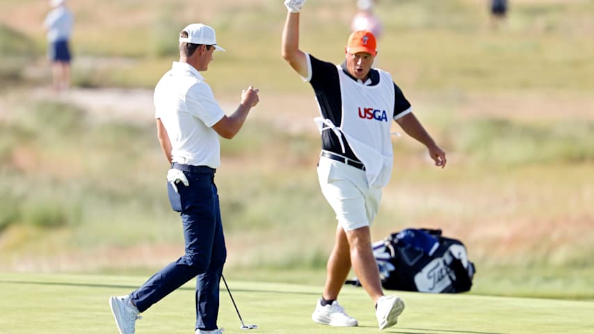 Amateur Preston Stout of the United States and his caddie celebrate after making birdie on the seventh green during the first round of the 126th U.S. OPEN at Shinnecock Hills Golf Club on June 18, 2026 in Southampton, New York. (Cliff Hawkins/Getty Images)