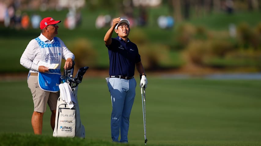 Dylan Wu of the United States prepares to play a shot on the ninth hole alongside his caddie during the second round of the Cognizant Classic 2026 at PGA National Resort And Spa on February 27, 2026 in Palm Beach Gardens, Florida. (Mike Ehrmann/Getty Images)