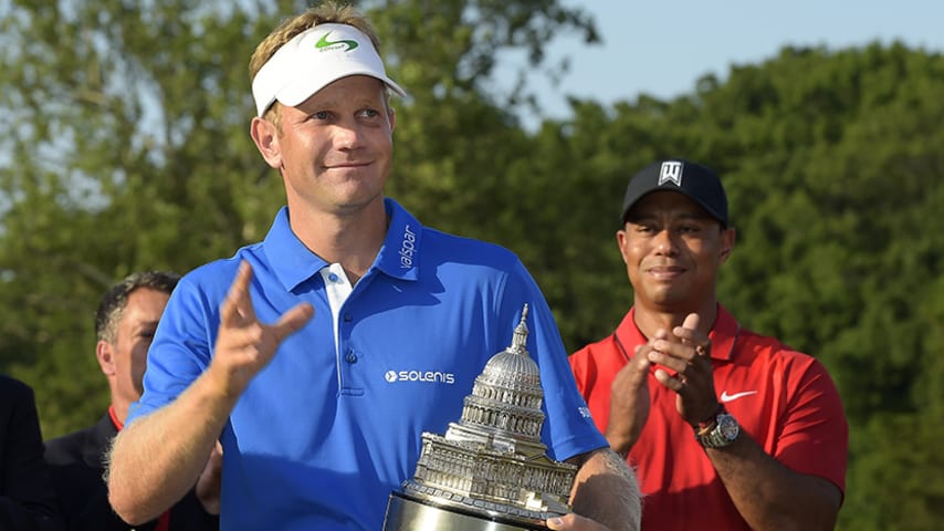 BETHESDA, MD - JUNE 26: Billy Hurley III acknowledges fans holding the winner's trophy as Tiger Woods looks on after the final round of the Quicken Loans National at Congressional Country Club (Blue) on June 26, 2016 in Bethesda, Maryland. (Photo by Stan Badz/PGA TOUR)